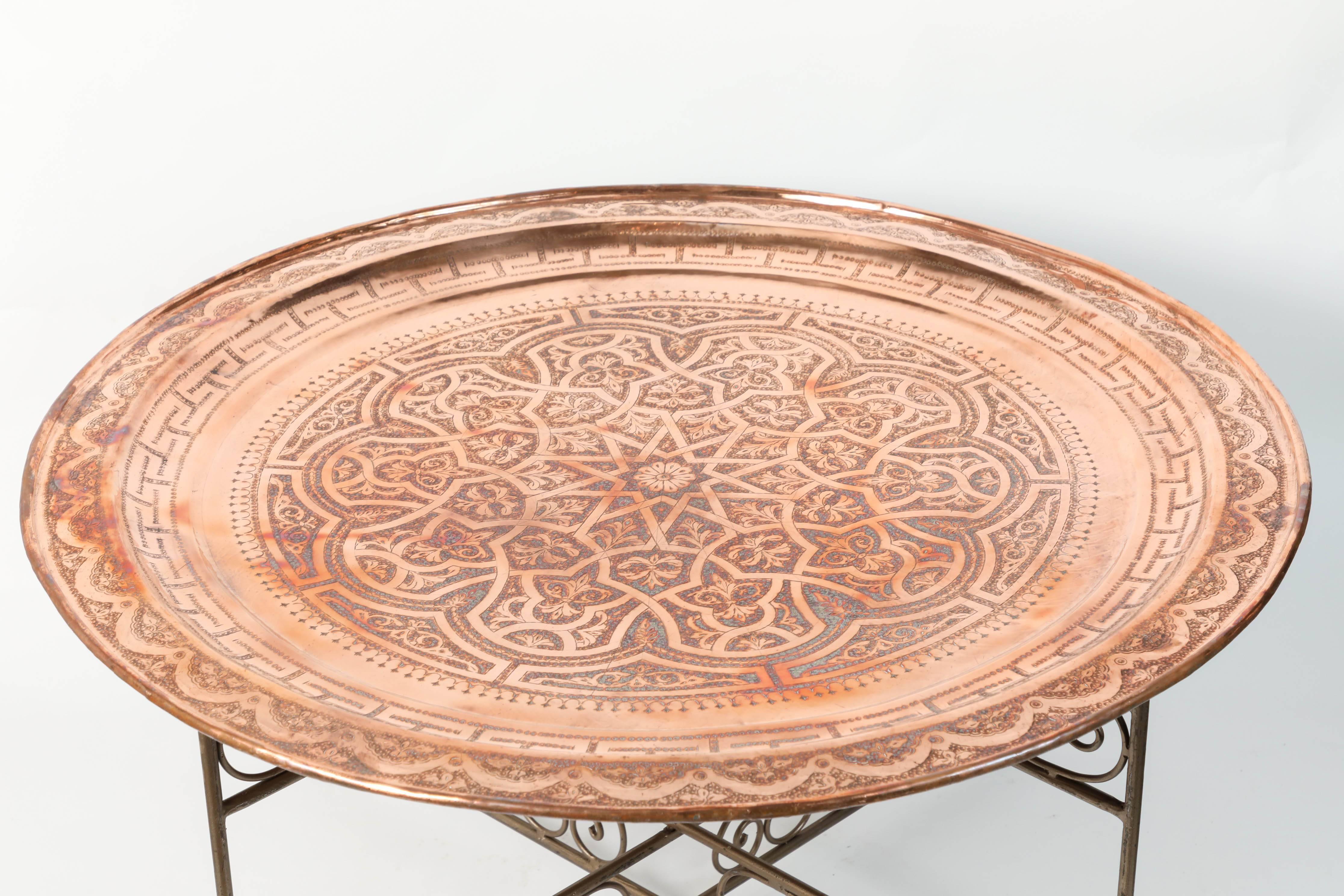 Moroccan Moorish large round copper tray table on iron folding base.
Nice handcrafted polished brass metal tray, hand-hammered with Moorish traditional designs.
Handmade in Fez by Master artisans from Morocco.
Great to use indoor or