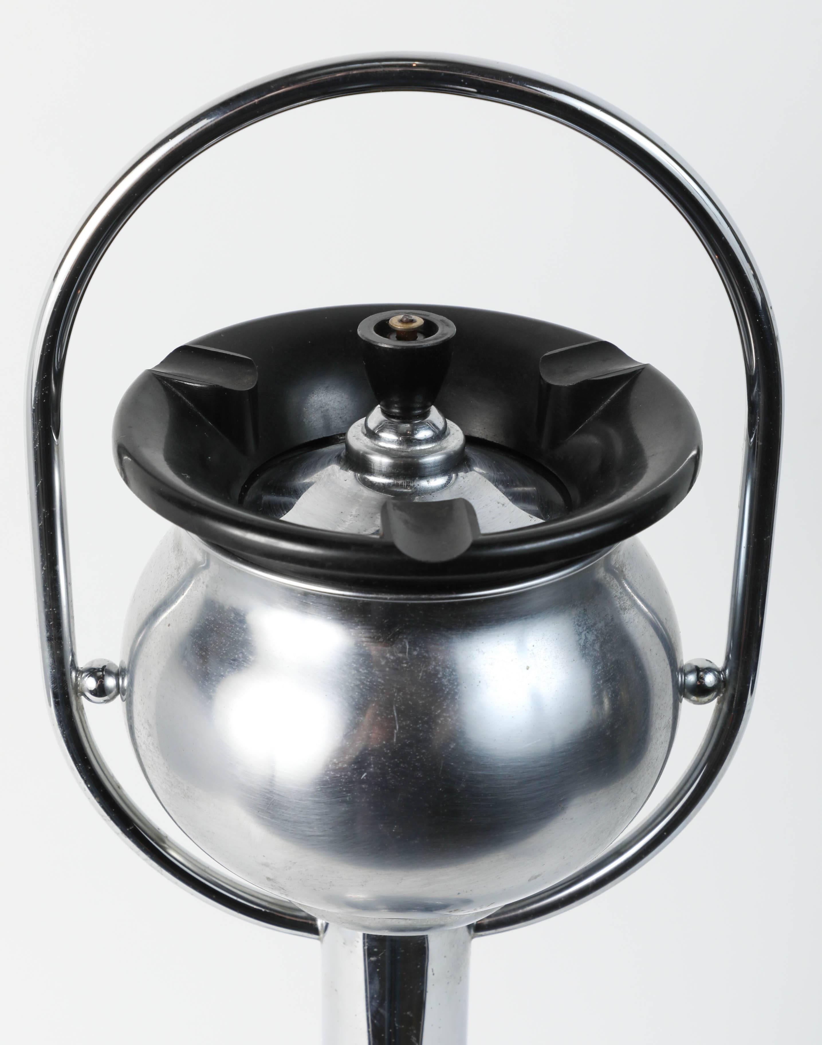 Fantastic chrome smoking stand ashtray in the style of designer Wolfgang Hoffman. 
Classic American Art Deco design. 
Top black Bakelite ring cigarette stubber. 
The base is weighted.
This piece is in remarkable original condition.
The ashtray