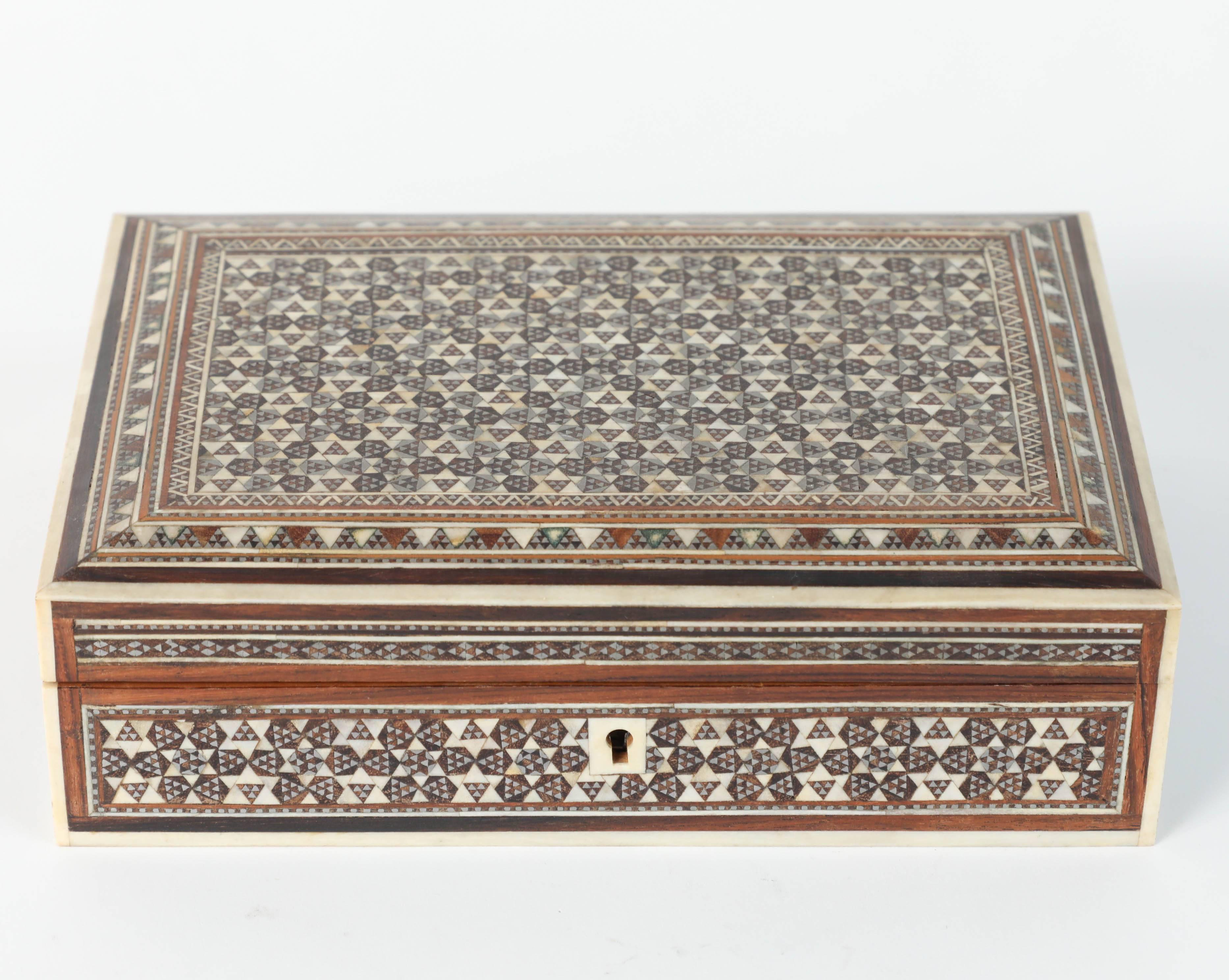 Antique Syrian wooden jewelry box inlaid with mother-of-pearl, bone and precious wood.
Middle Eastern box handcrafted in very fine Moorish micro mosaic diamonds, and a continuous hexagonal motif design intricately inlaid with bone, mother-of-pearl,