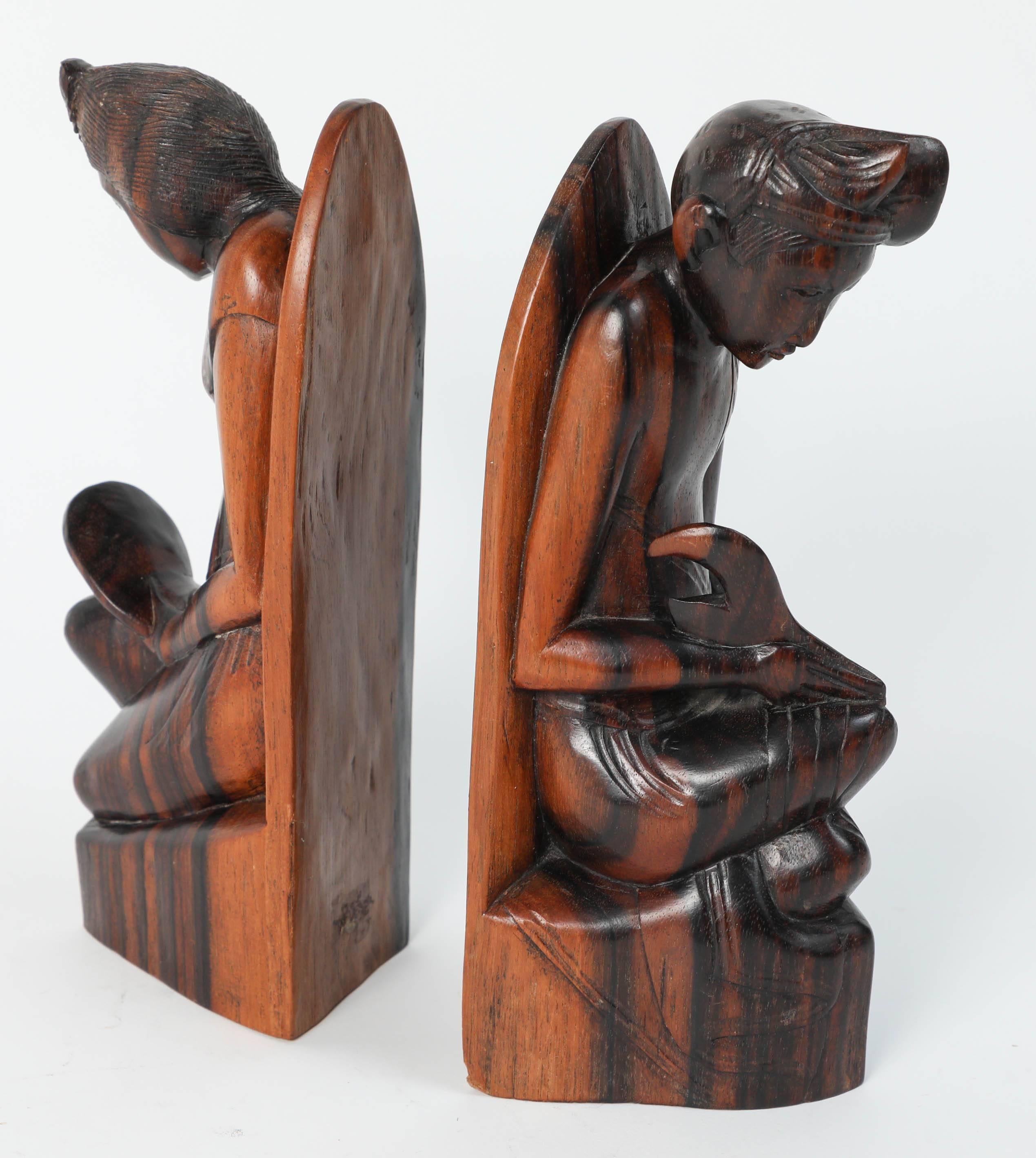 Vintage midcentury hand-carved wooden Balinese bookends.
Hand-carved sculpture in wood depicting a Balinese couple.
Dimensions: 7