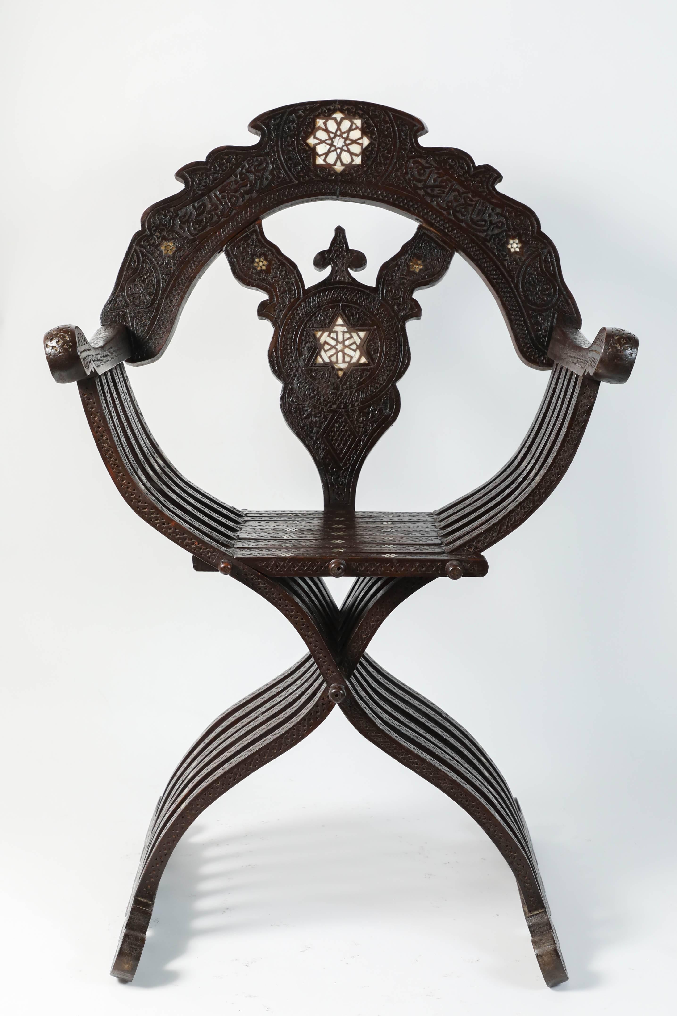 Antique handcrafted 19th century Syrian throne armchair hand-carved and inlaid with mother-of-pearl on solid walnut wood.
Middle Eastern armchair with inlaid mother-of-pearl in Star of David insets, cut-out back hand-carved with Arabic calligraphy