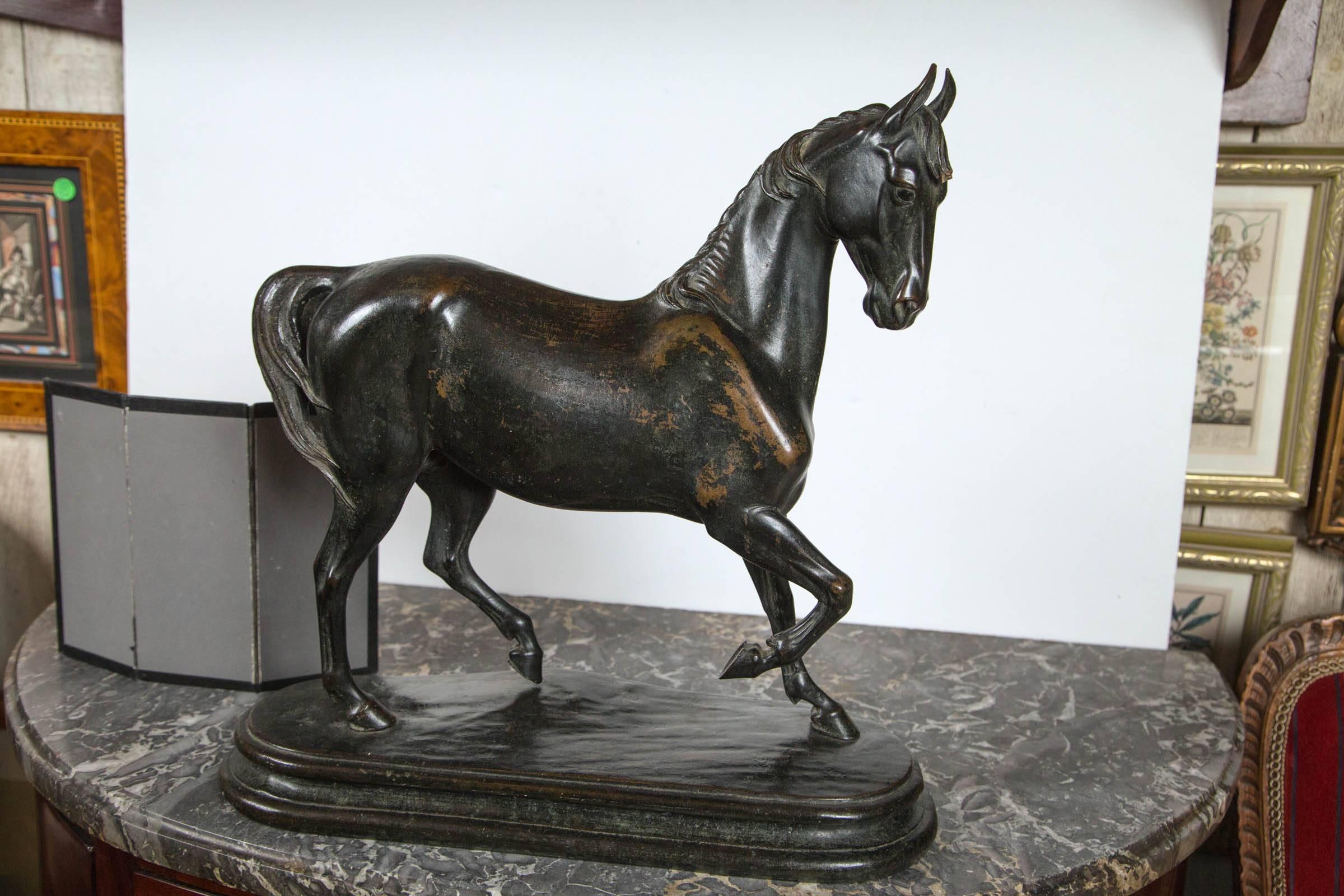 A very well cast and chased standing horse, upon the original cast bronze base. The base cast separately. Worn dark brown patina. dimensions listed are overall.