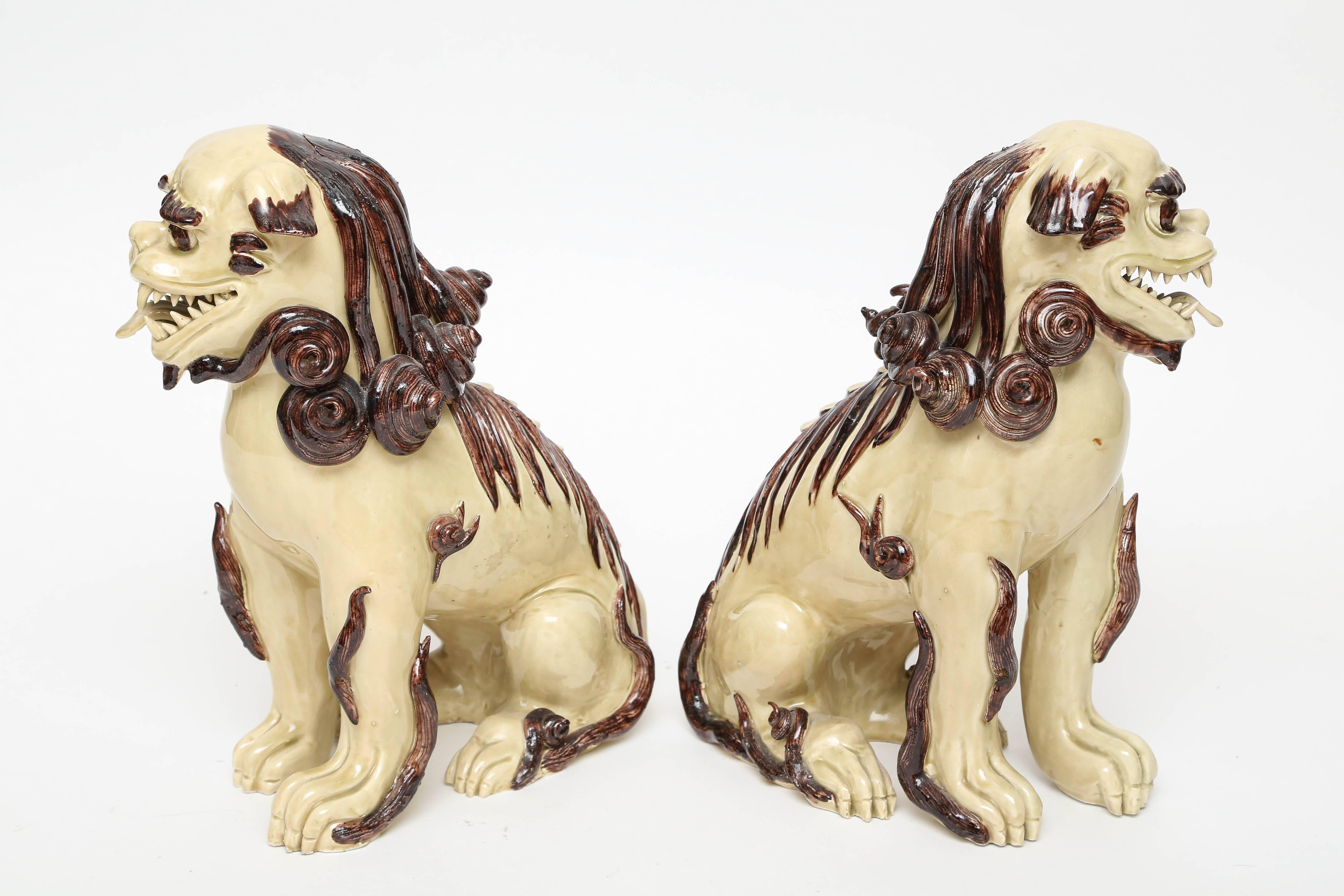 Lovely pair of cream and brown glazed Foo dogs made in Italy for Paul Hanson.