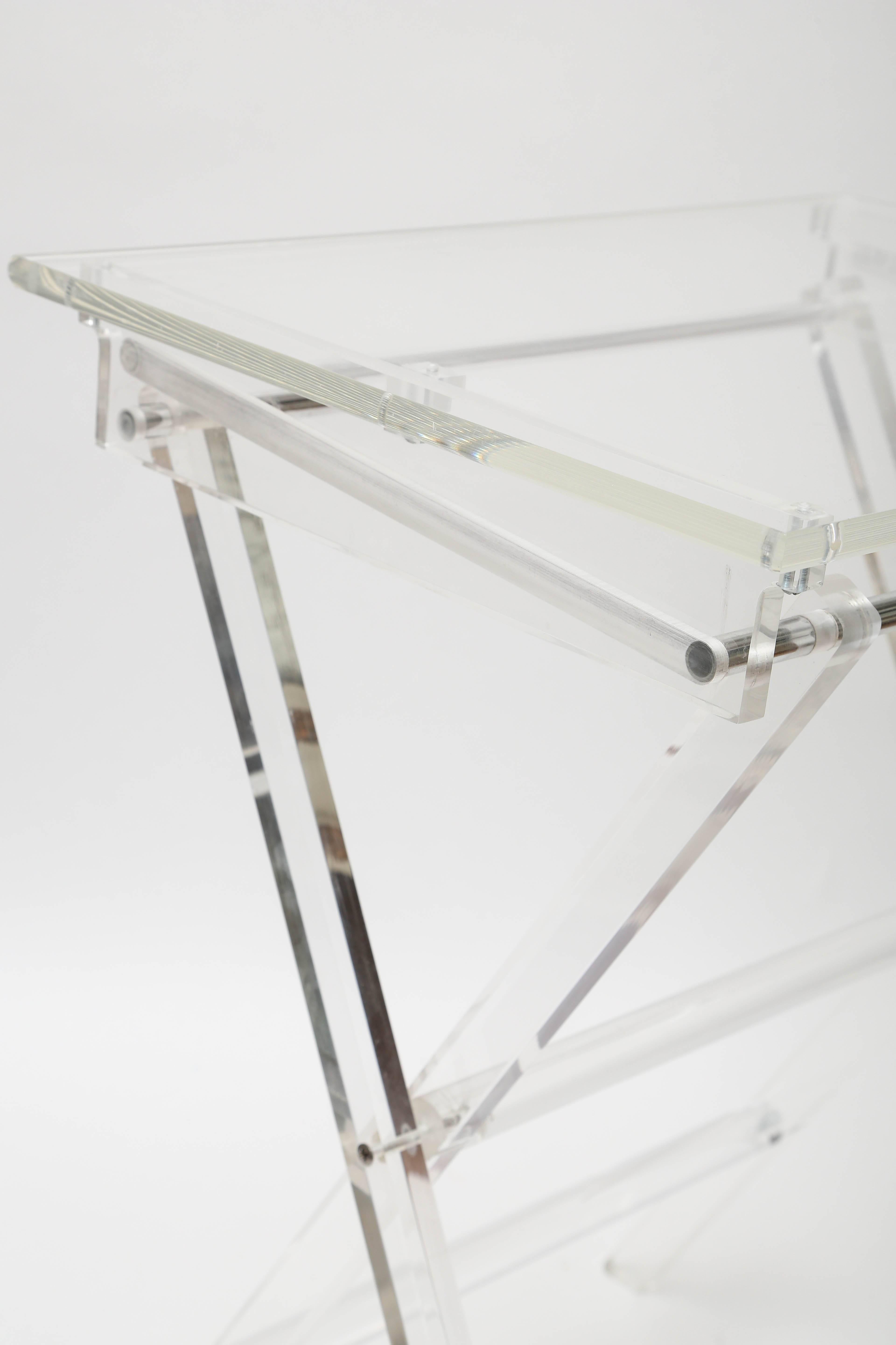 Set of two Lucite tray tables on stand. Each tray measures 15 x 20 x 25.5.