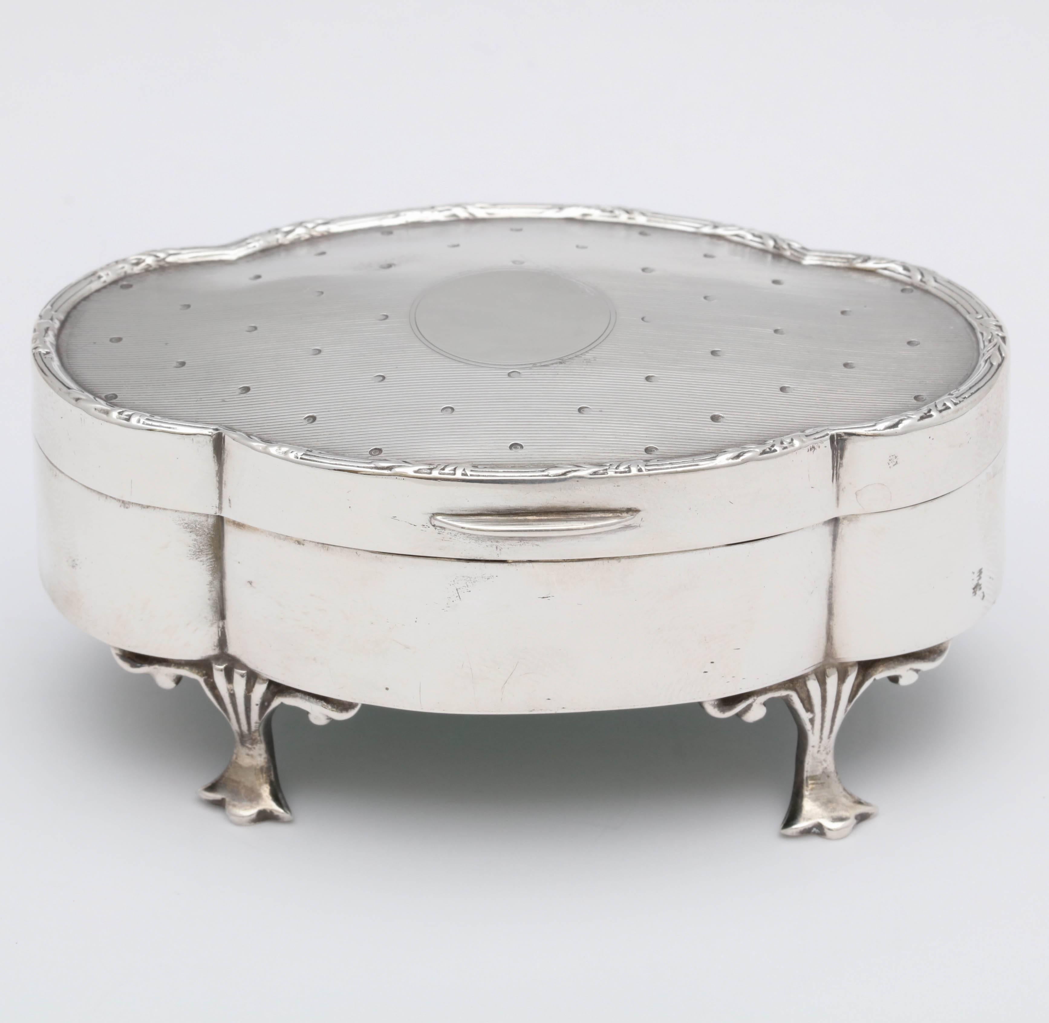 Art Deco, sterling silver, jewelry box on paw feet, Birmingham, England, 1918, H. Matthews - Maker. Over 1 3/4 inches high x over 3 3/4 inches wide x 2 1/4 inches deep; weights 2.580 troy ounces. Underside of lid is gilded. Design on lid makes the