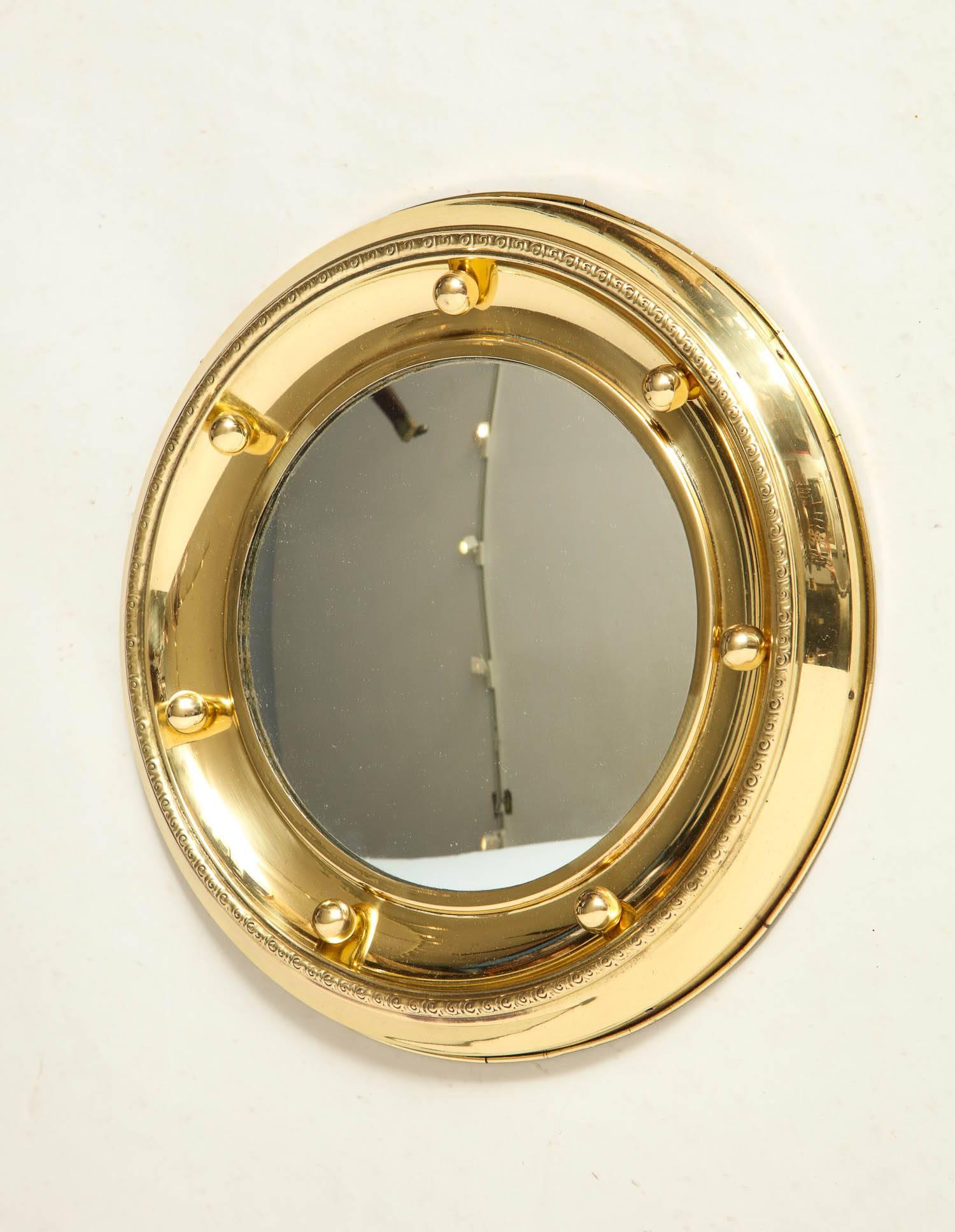 Fun English 1920s brass porthole mirror with original convex glass having seven brass balls.