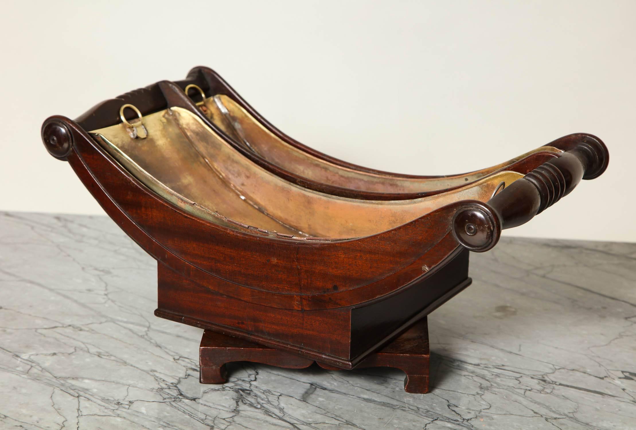 Very fine and rare George III mahogany divided Stilton cradle having bolster turned ends, original brass liners and standing on bracket base with original hand-forged iron bolt, the whole with good rich color and great form.