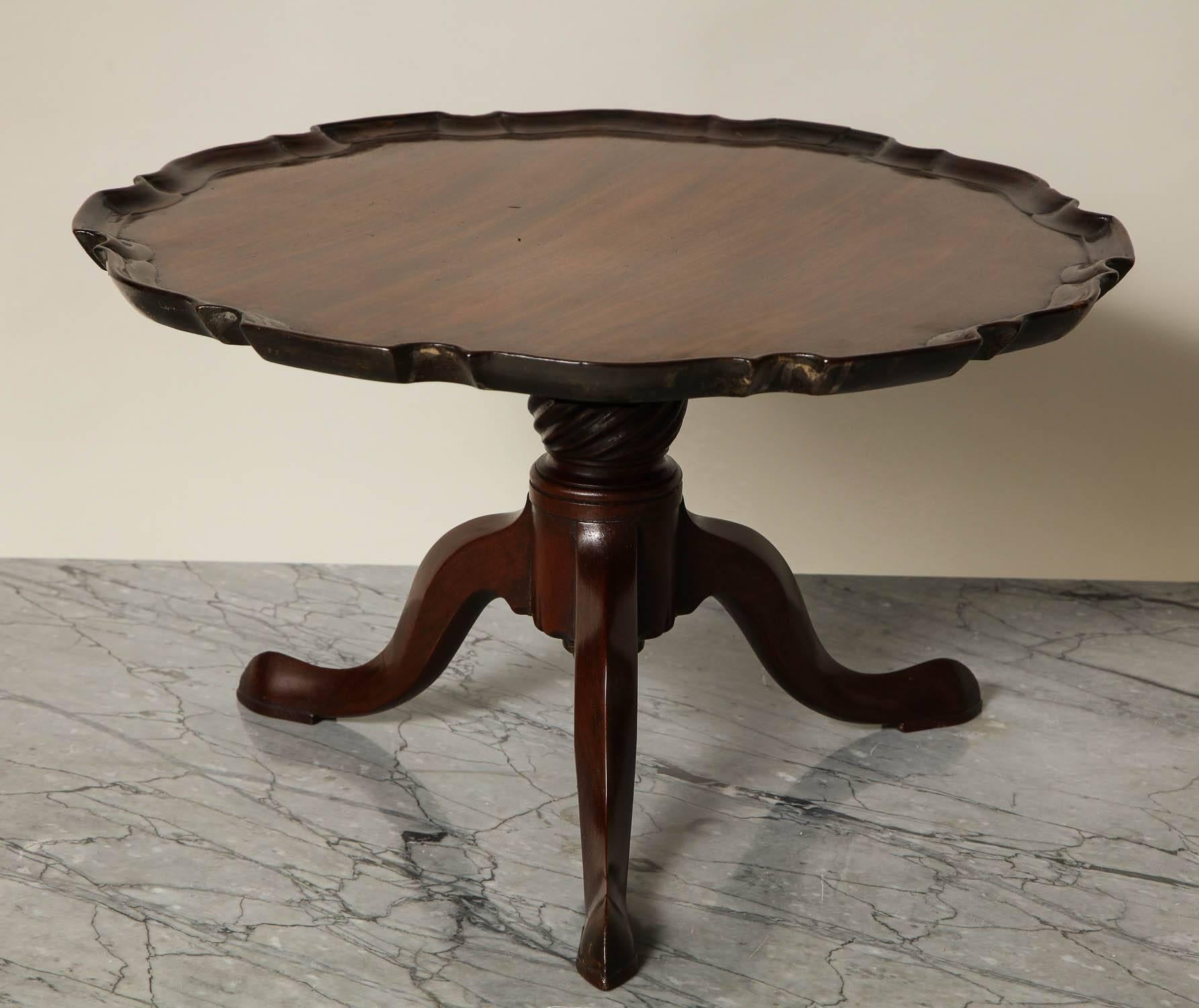 Most unusual George III mahogany Lazy Susan, the piecrust scalloped top fashioned from a single and well figured plank, over revolving shaft with spiral fluted turning, standing on tripod base with slipper feet, the whole possessing good rich color
