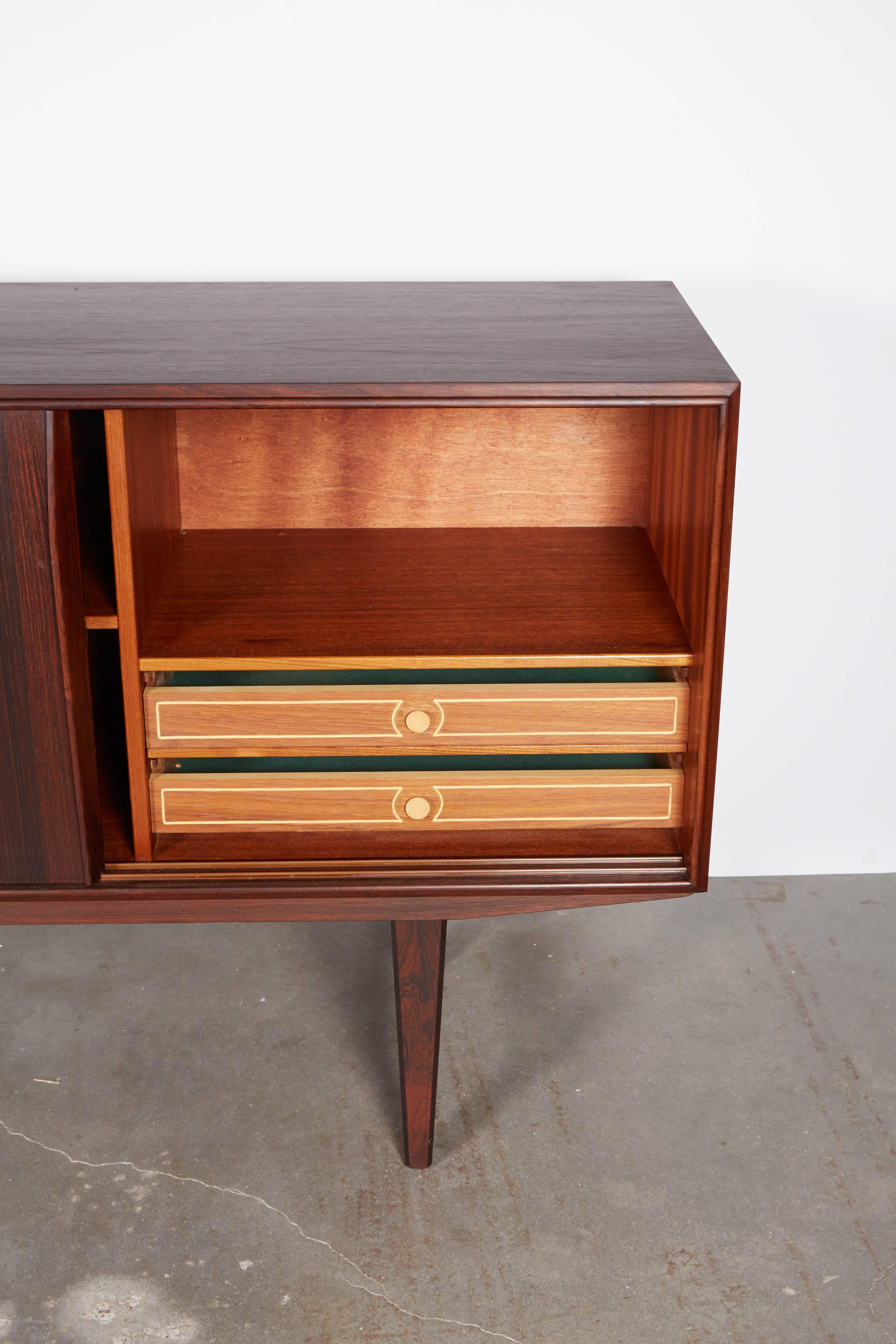 Vintage 1960s Rosewood Buffet 

This E.W. Bach credenza is in excellent condition, like brand new, and it has 3 sliding doors. The doors are great for media storage because the doors don't hang open when you need to use your remote controls. The