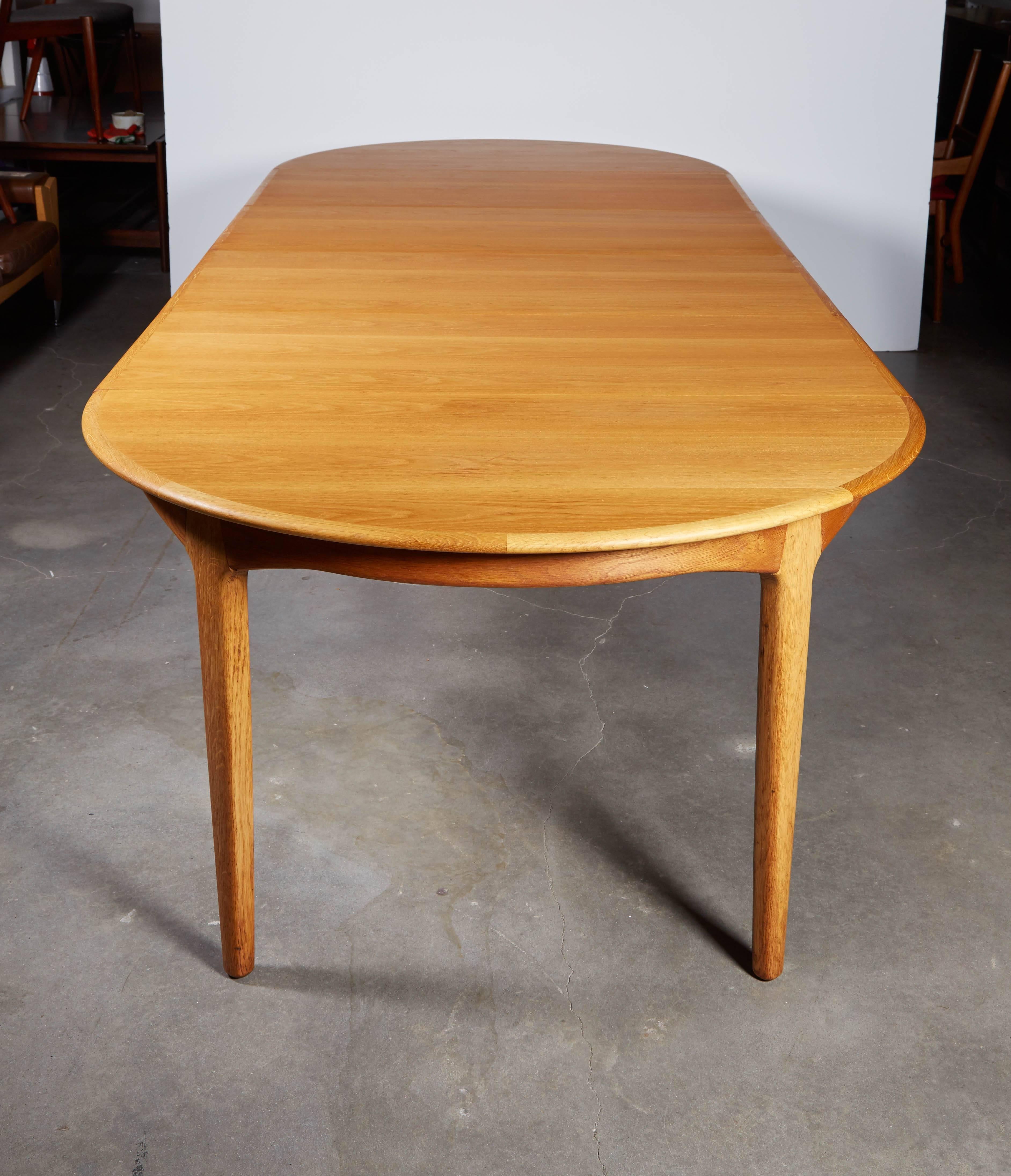 Vintage 1950s Round Dining Table by Henning Kjaernulf

This mid century round dining table is in excellent condition and has four 20