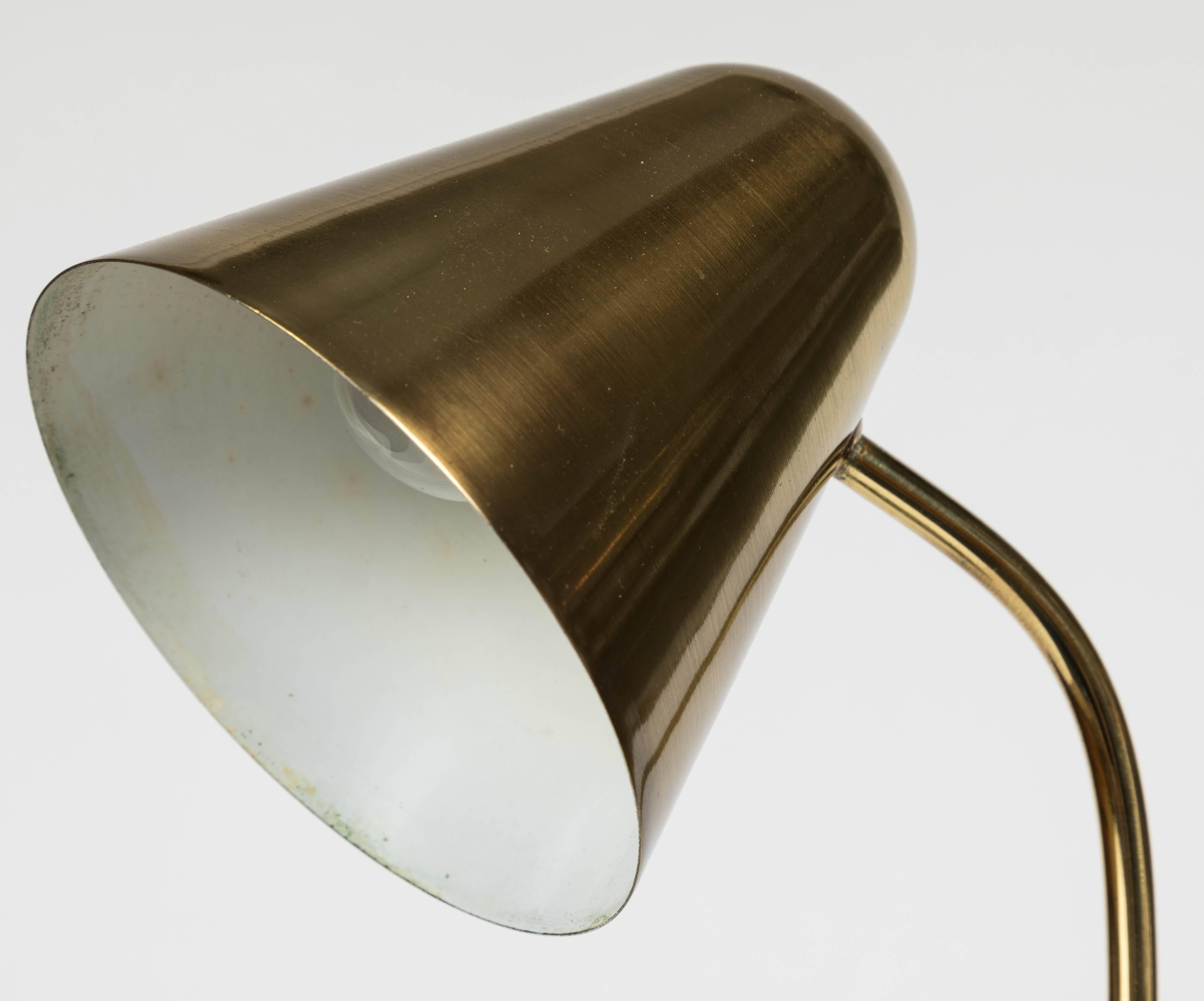 1950s brass table lamp attributed to Jacques Biny. A exceptionally clean and simple design executed in patinated brass with white painted inner shade. Quintessentially midcentury French in its conception and execution attributed to the incomparable