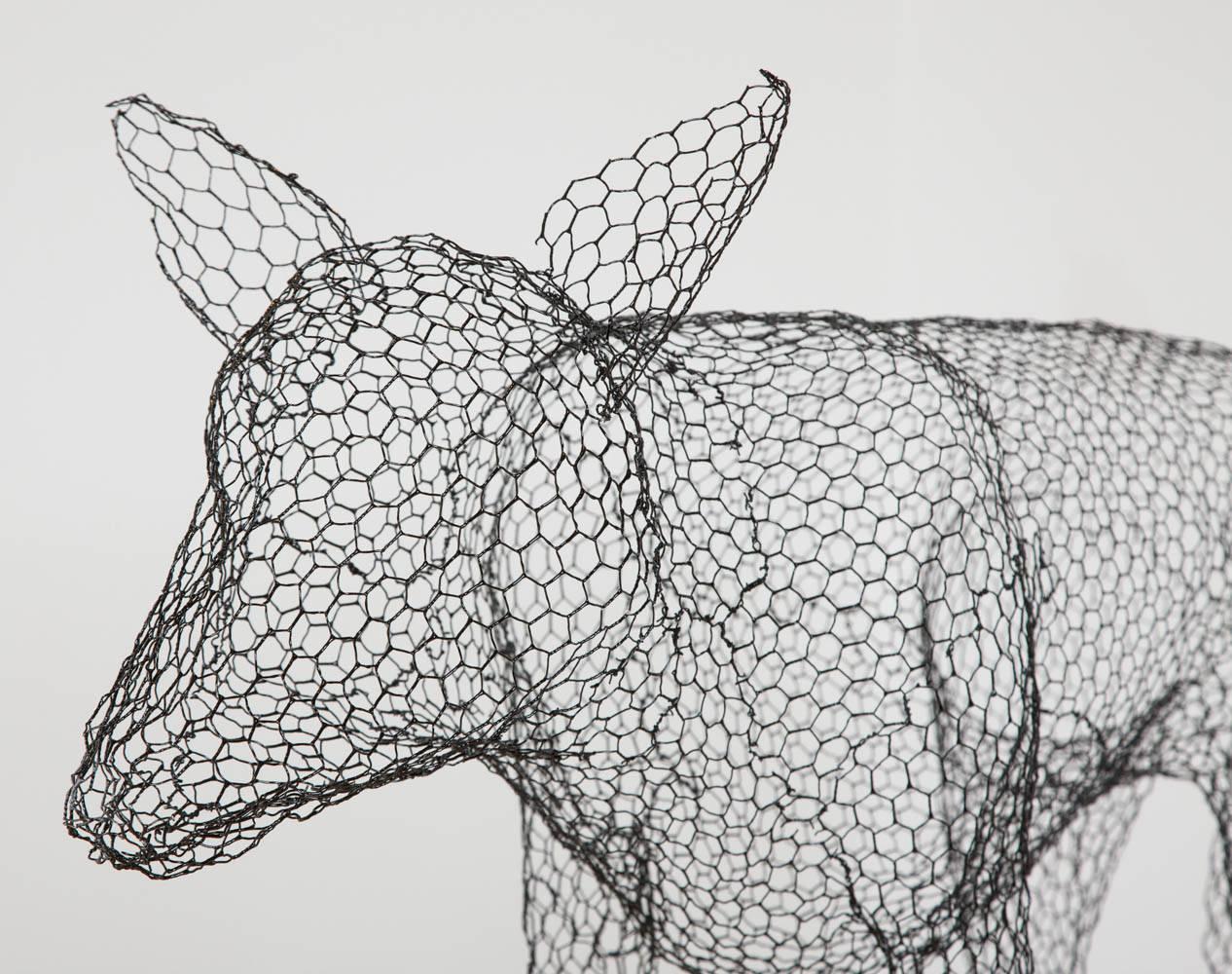 Hand-formed wire sculpture of a wolf,
finished in black enamel paint.
