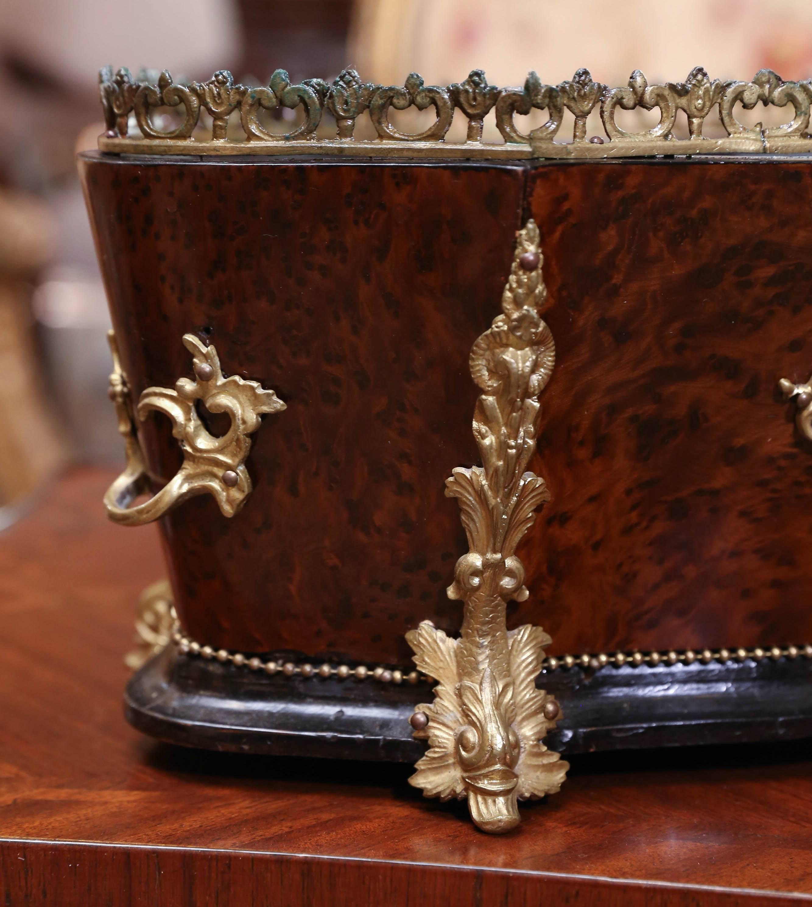 Buried wood jardiniere in oval form with bronze doré embellishments
with bronze handles on opposing sides
ebonized wood base with beaded trim.