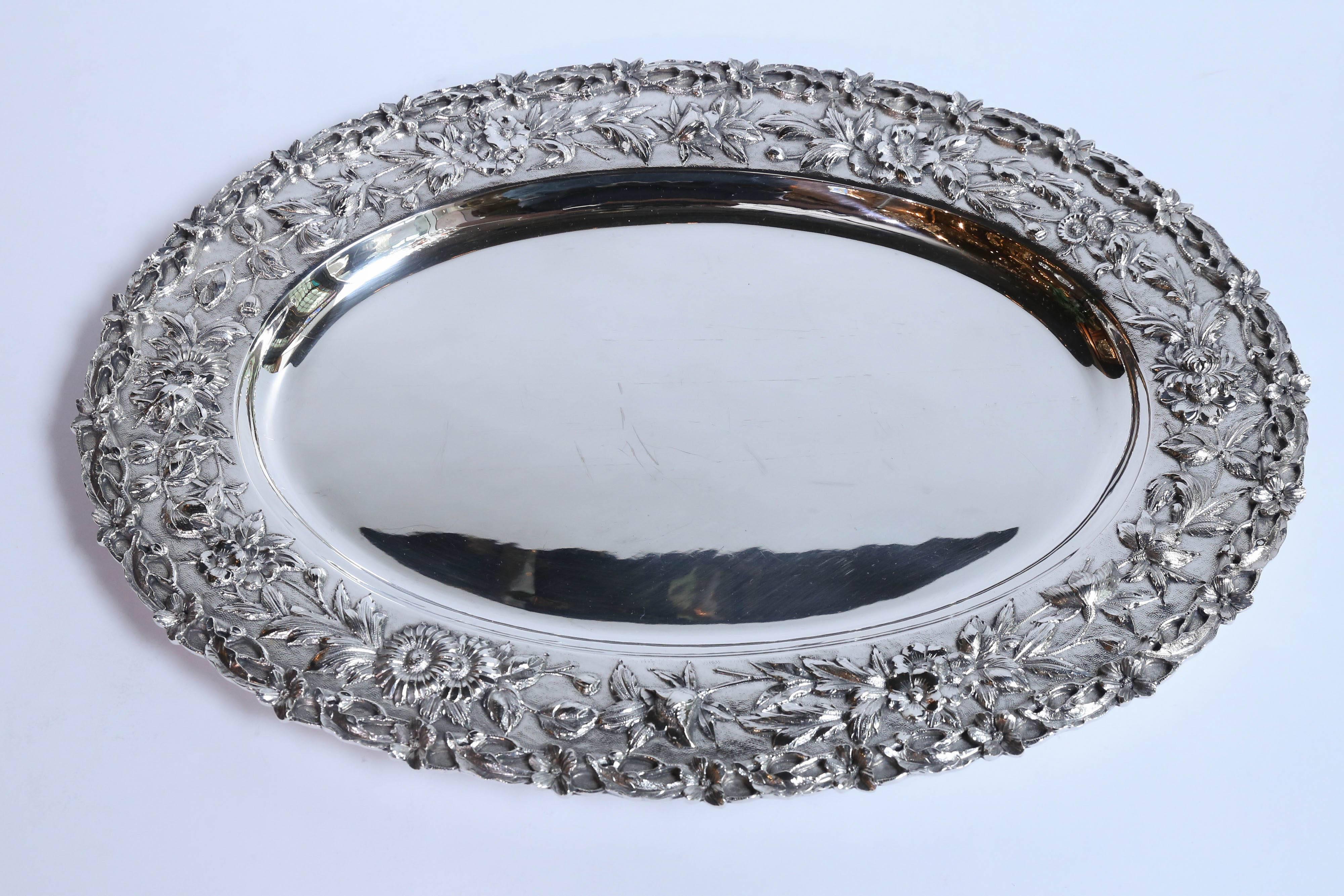 Lovely tray with floral border made of sterling silver.