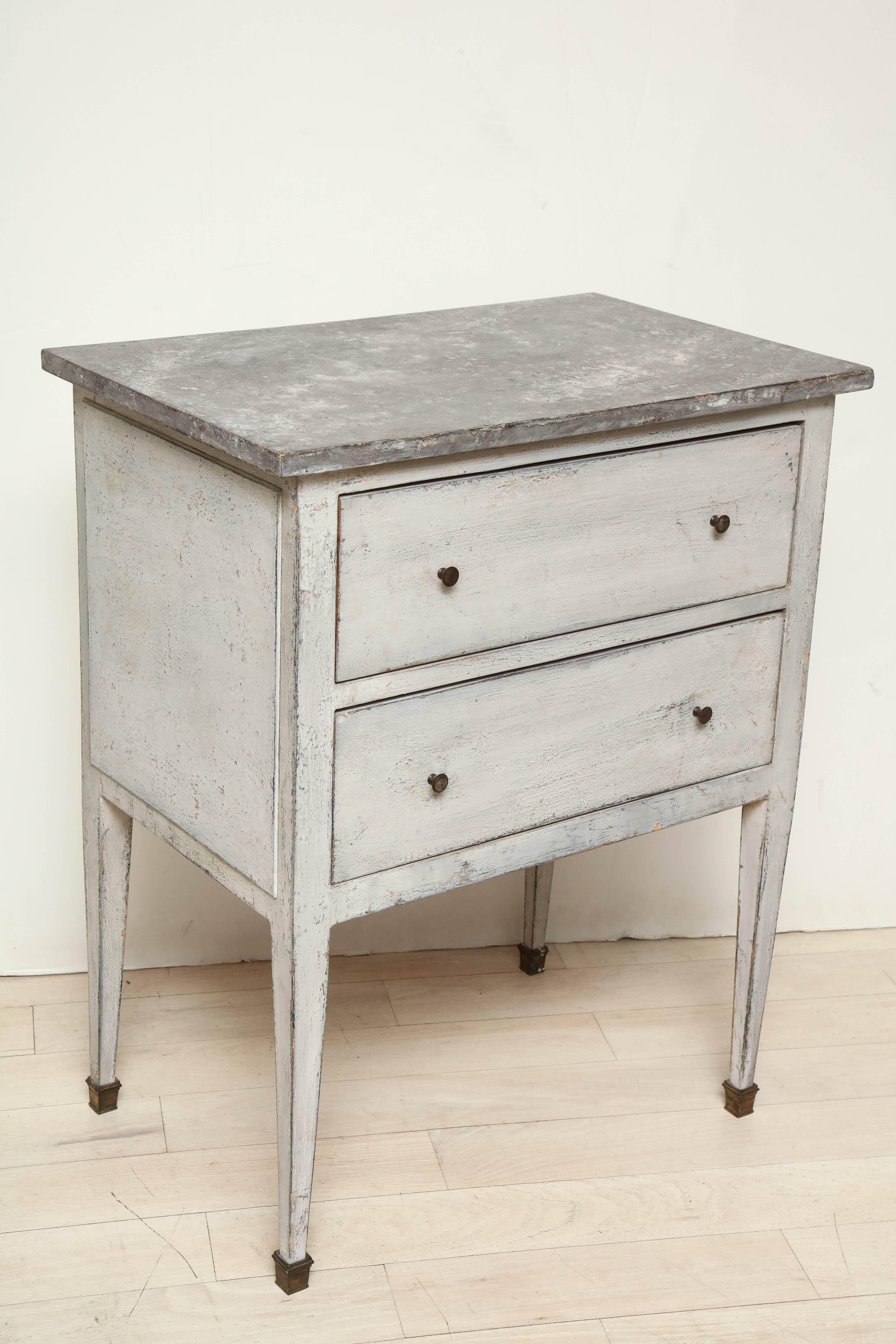 Small white painted two-drawer nightstand or side table with a faux bluestone top and brass sabots.