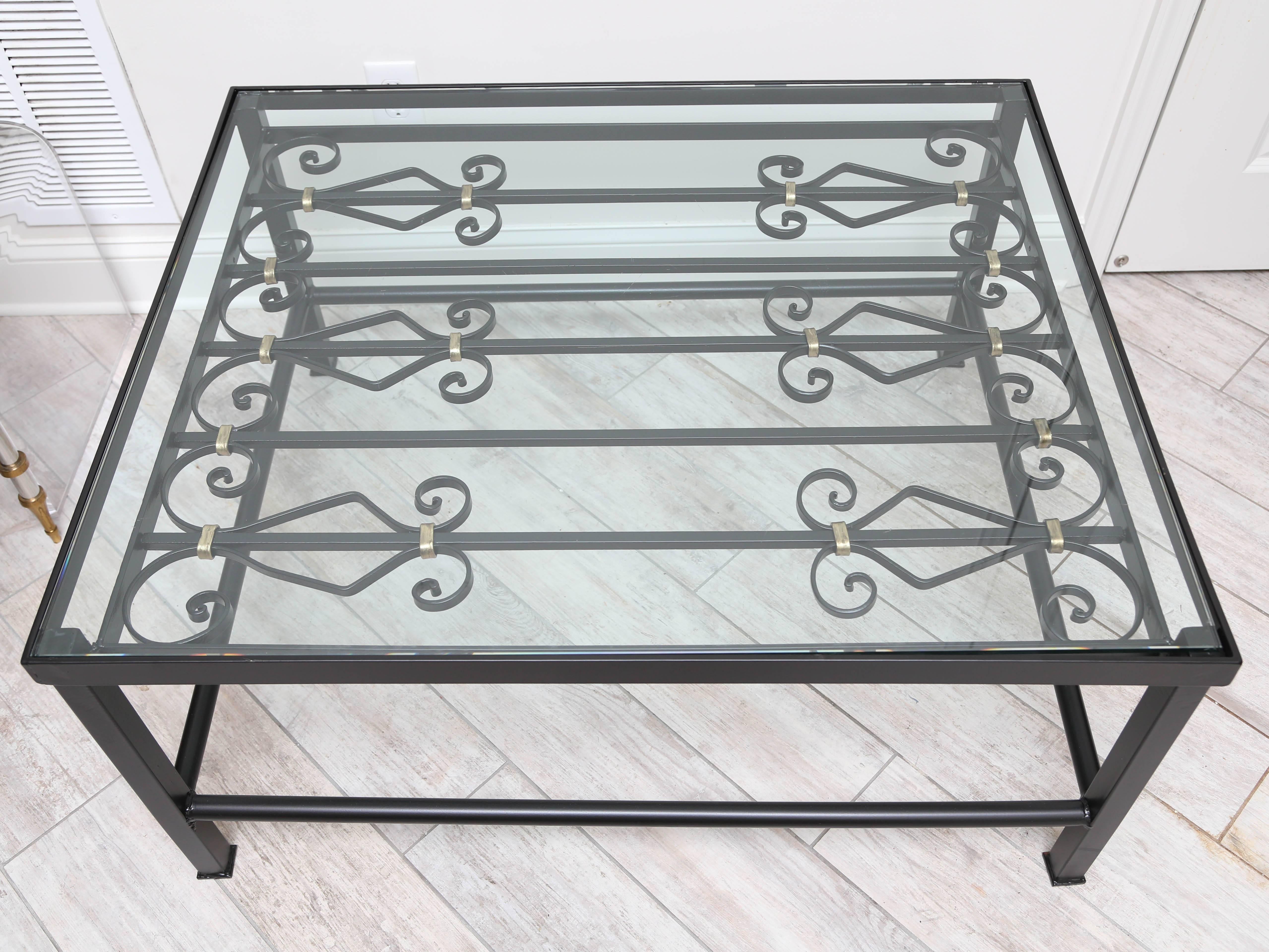 Vintage wrought iron gate cocktail table with glass top. 