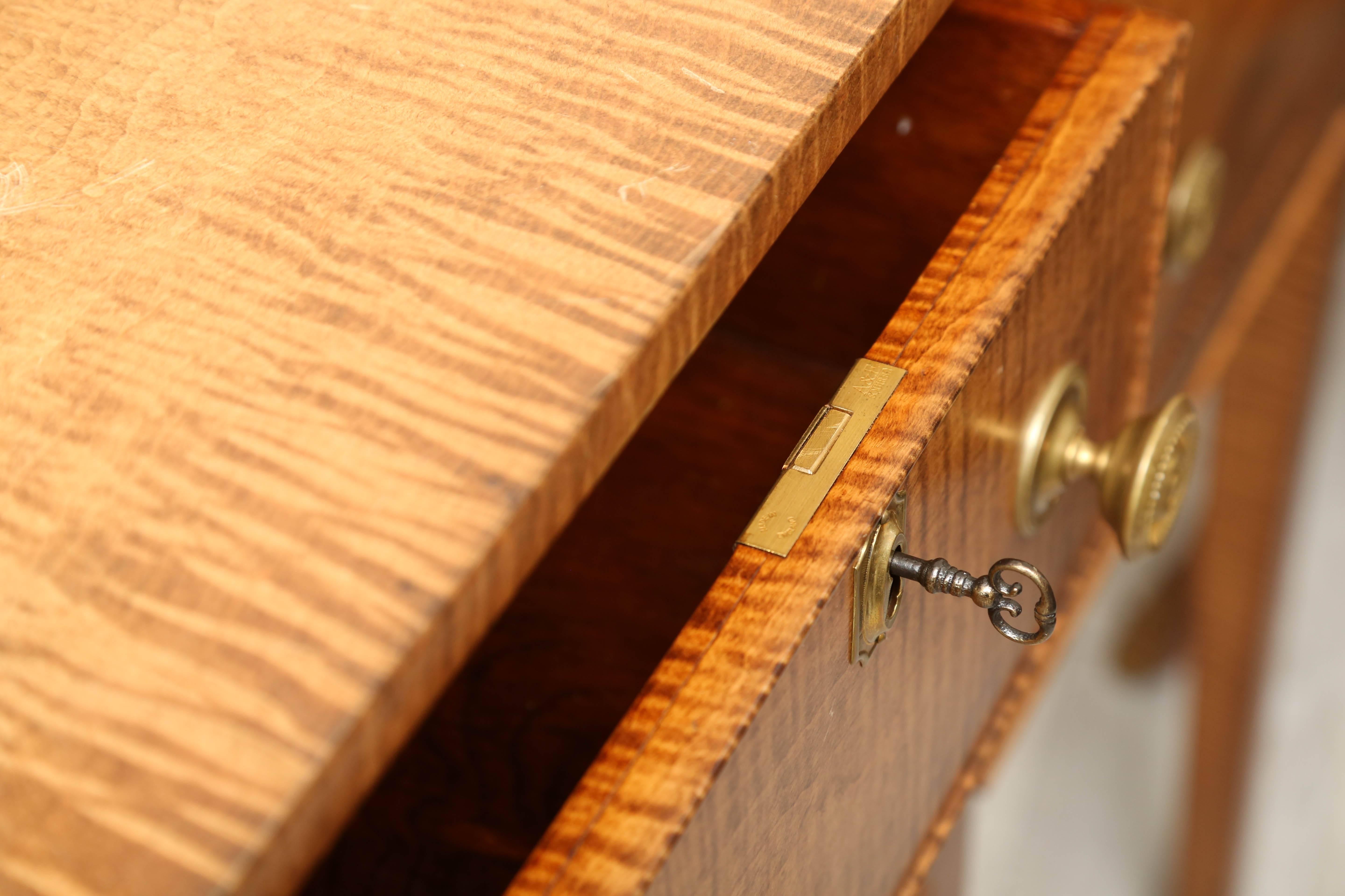 Handsome tiger maple English sideboard with three ample drawers for storage.