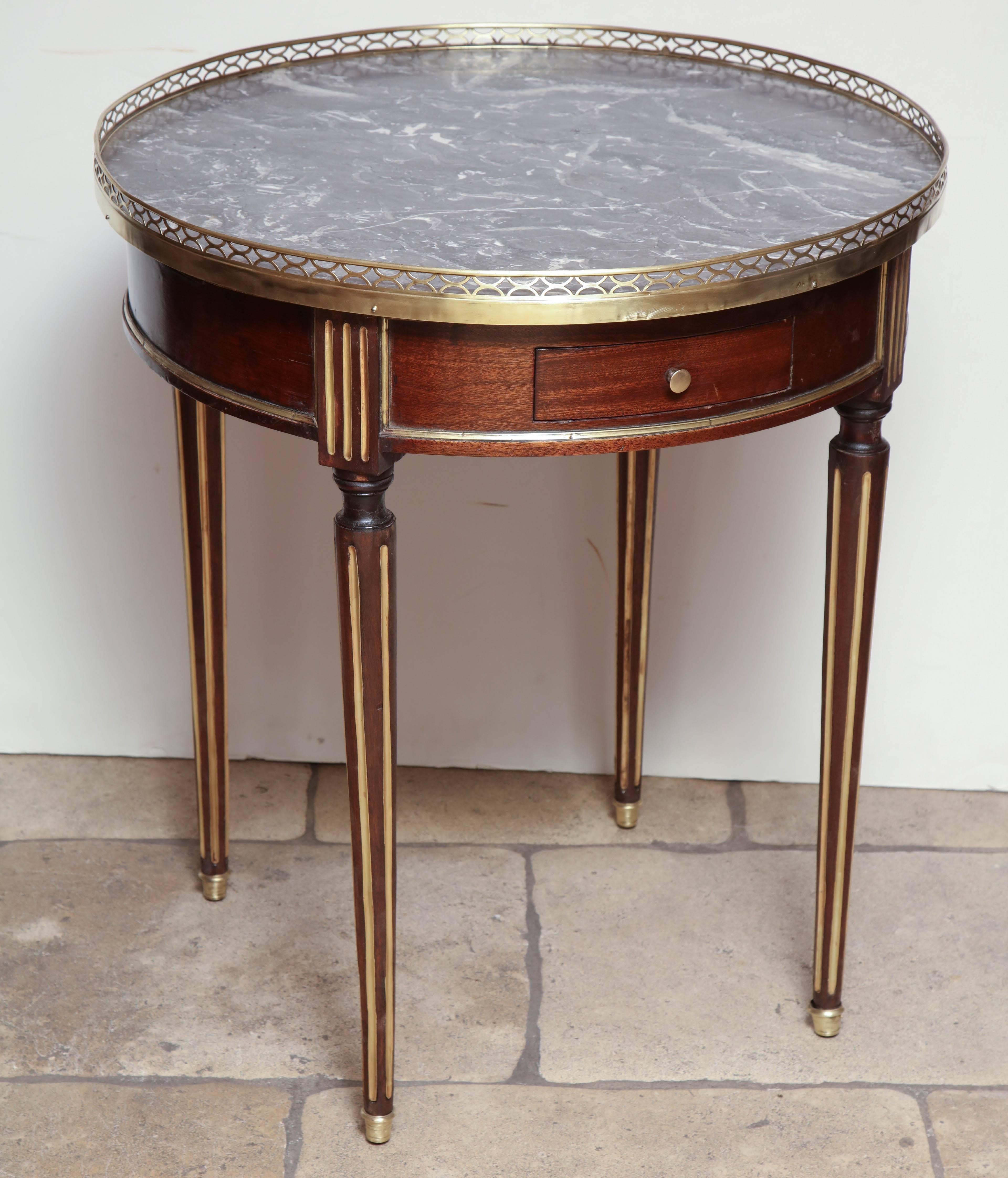 French Louis XVI marble-top pierced bronze gallery Boulliotte table with brass and gilded trim with drawer and candle slides.