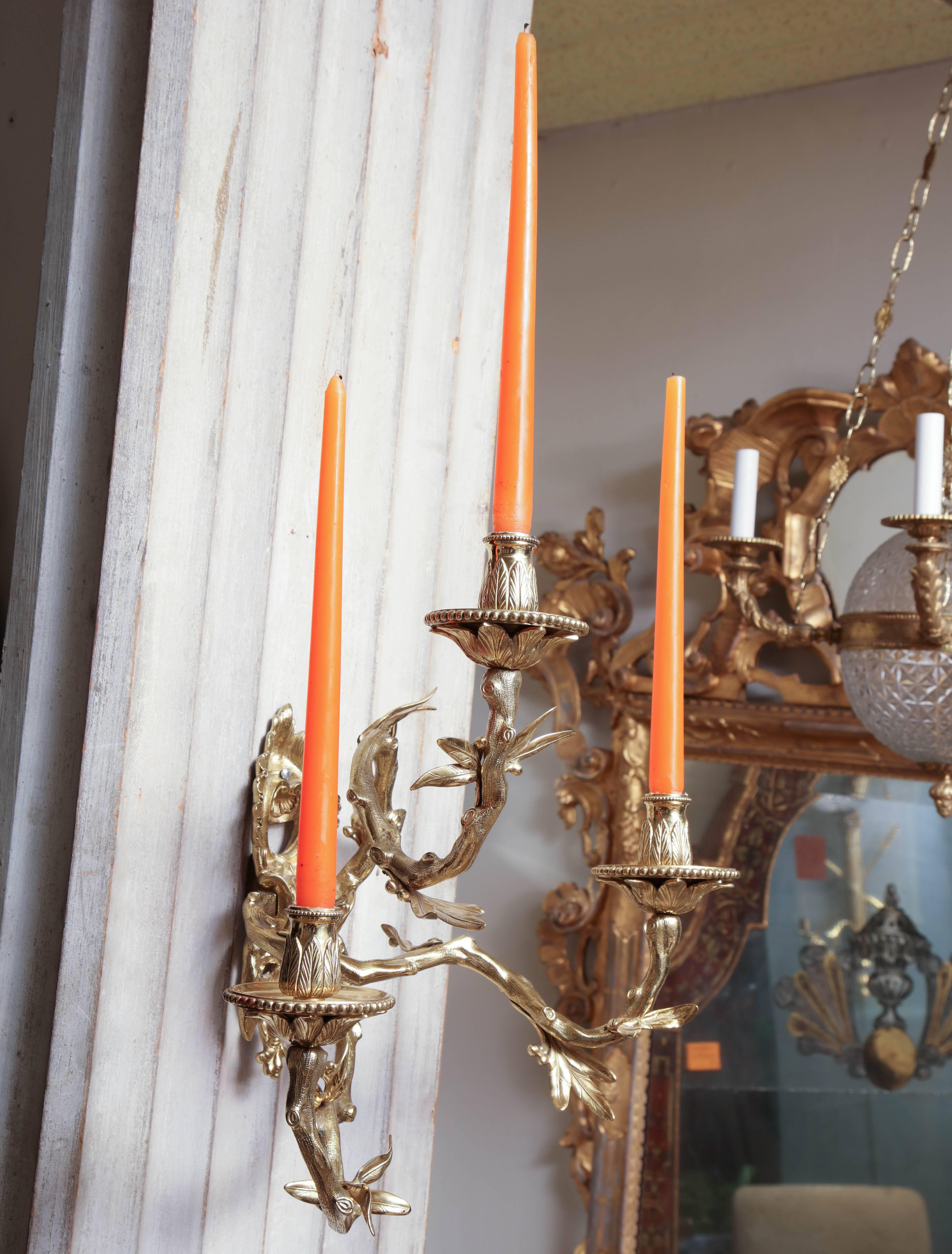 Fine Left and Right Pair of French Regence gilt bronze three arm wall lights with leaf branches and acanthus cups and bobeches.