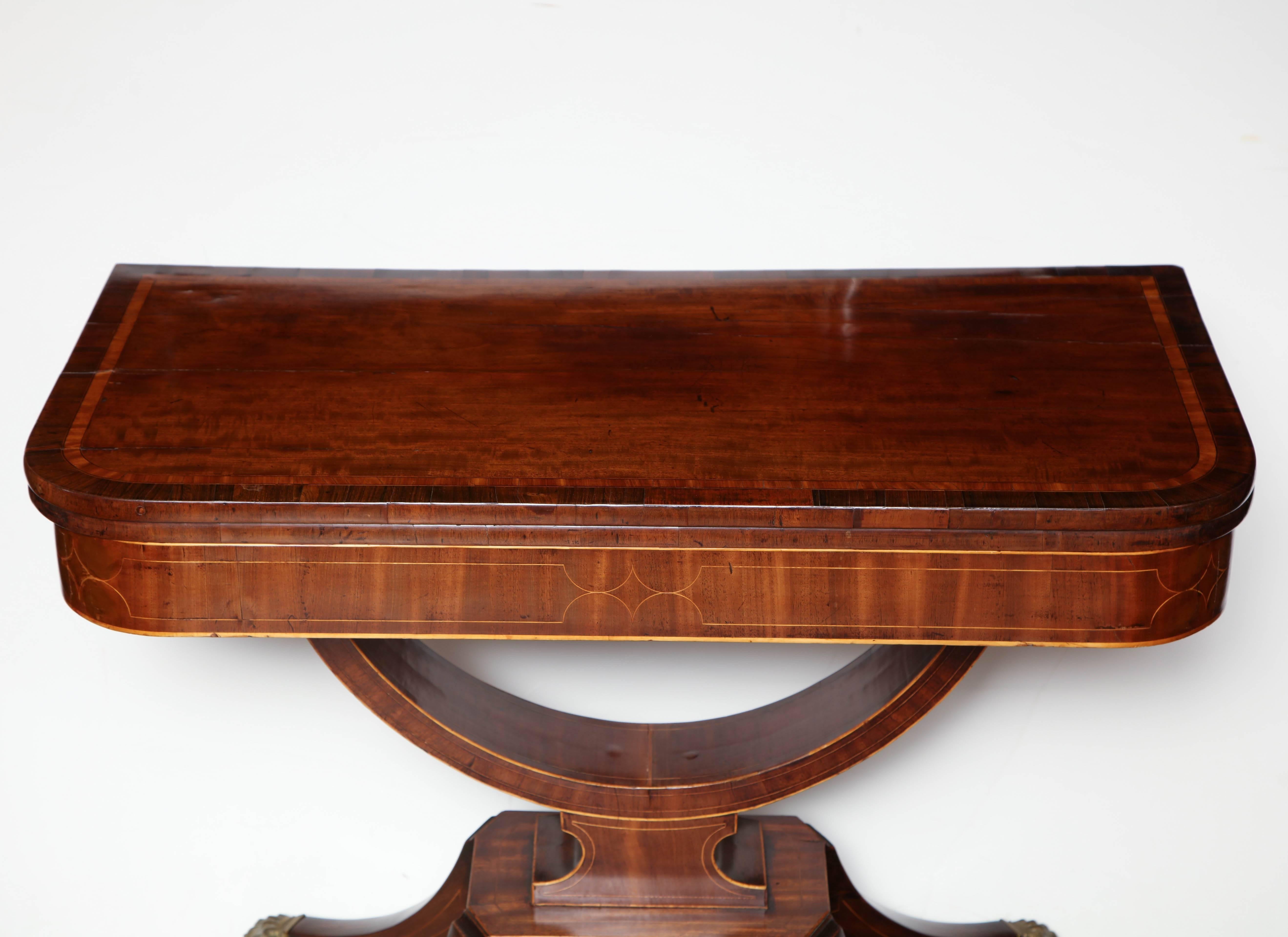 Pair of English Regency rosewood inlaid fold over crad tables wirth out-swept leg pedestal base and paw foot caster feet.