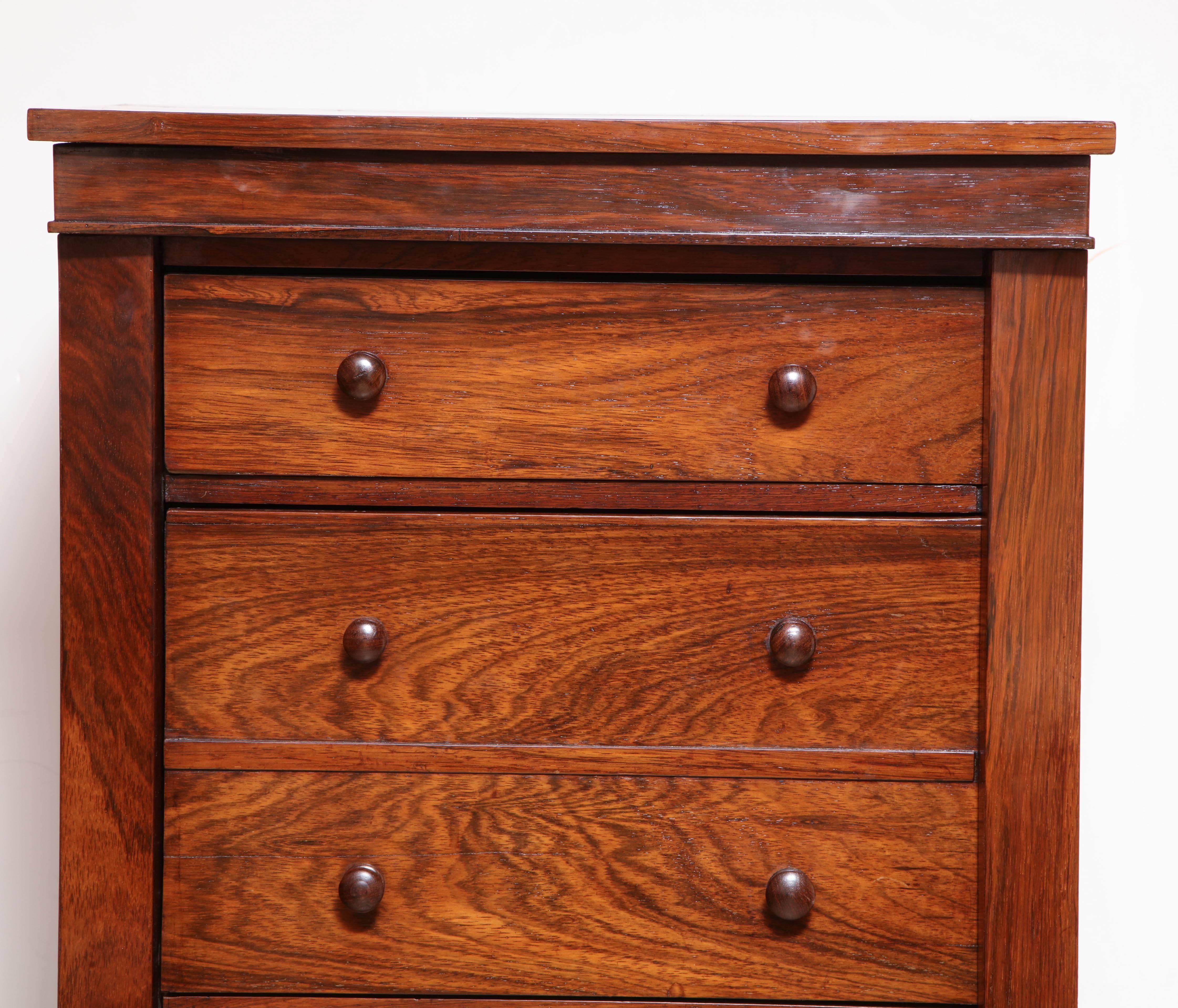 English Late Regency rosewood Wellington drop front desk with a fitted interior and a tooled leather writing surface.