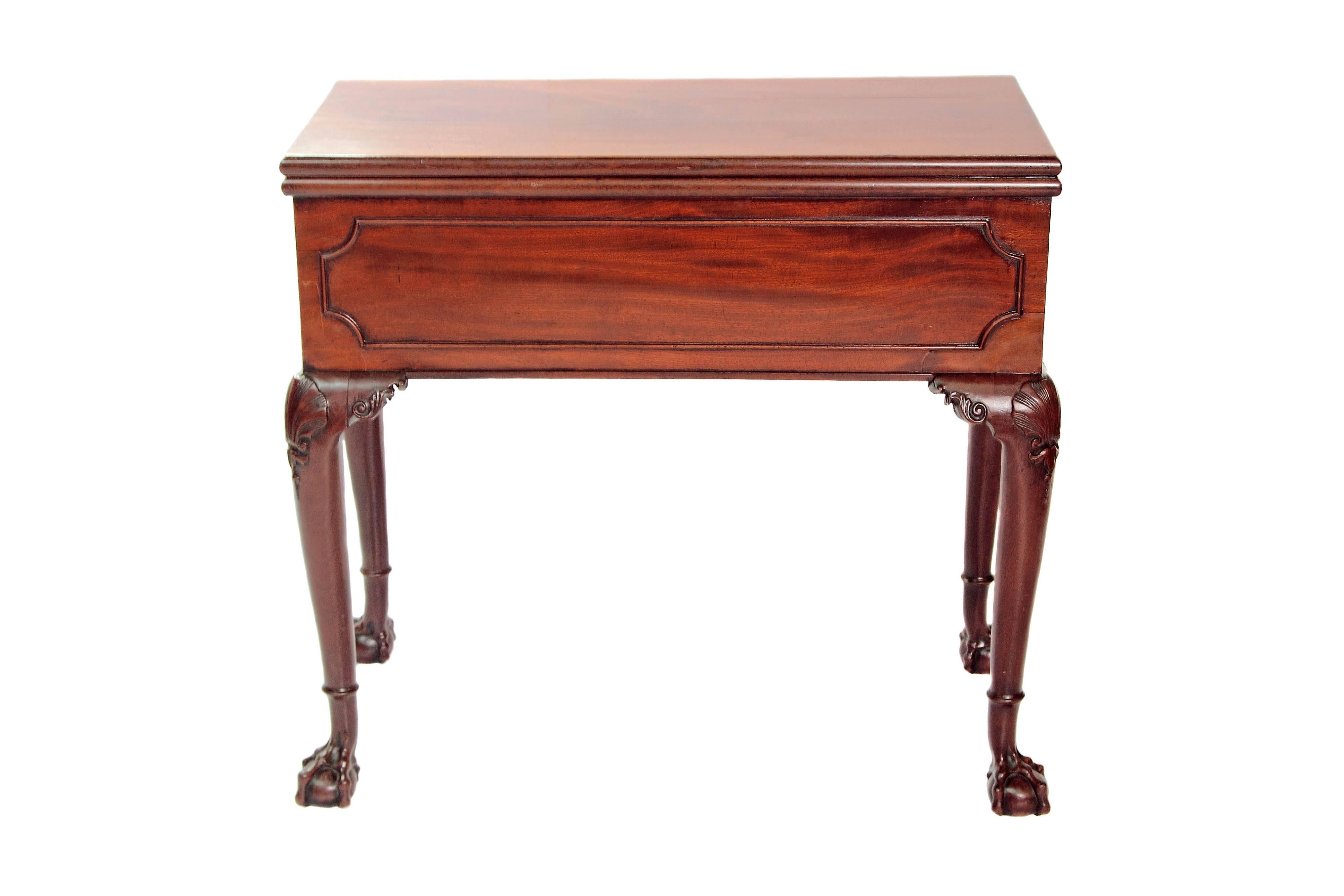 A George II mahogany pier/tea/games bureau-table. The mahogany top is supported on a hinged back leg when opened. The top when opened conceals the game table and a harlequin pop-up cabinet which contains drawers and paper pigeon holes. All rests on