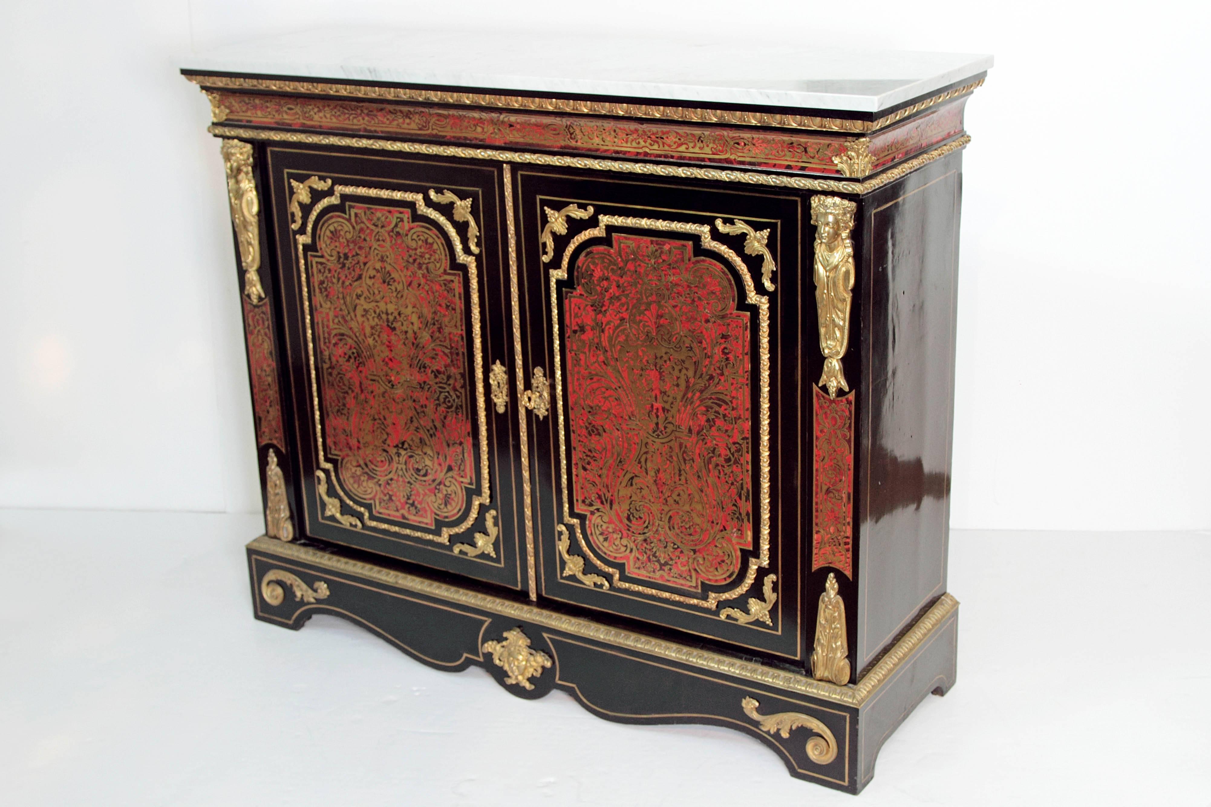 A 19th century French neoclassical / Louis XVI- style cabinet with Boulle work panels in red tortoise and gilded brass on doors, beside doors, and frieze (above doors and each side), the whole having a black body, white marble top, ormolu decoration