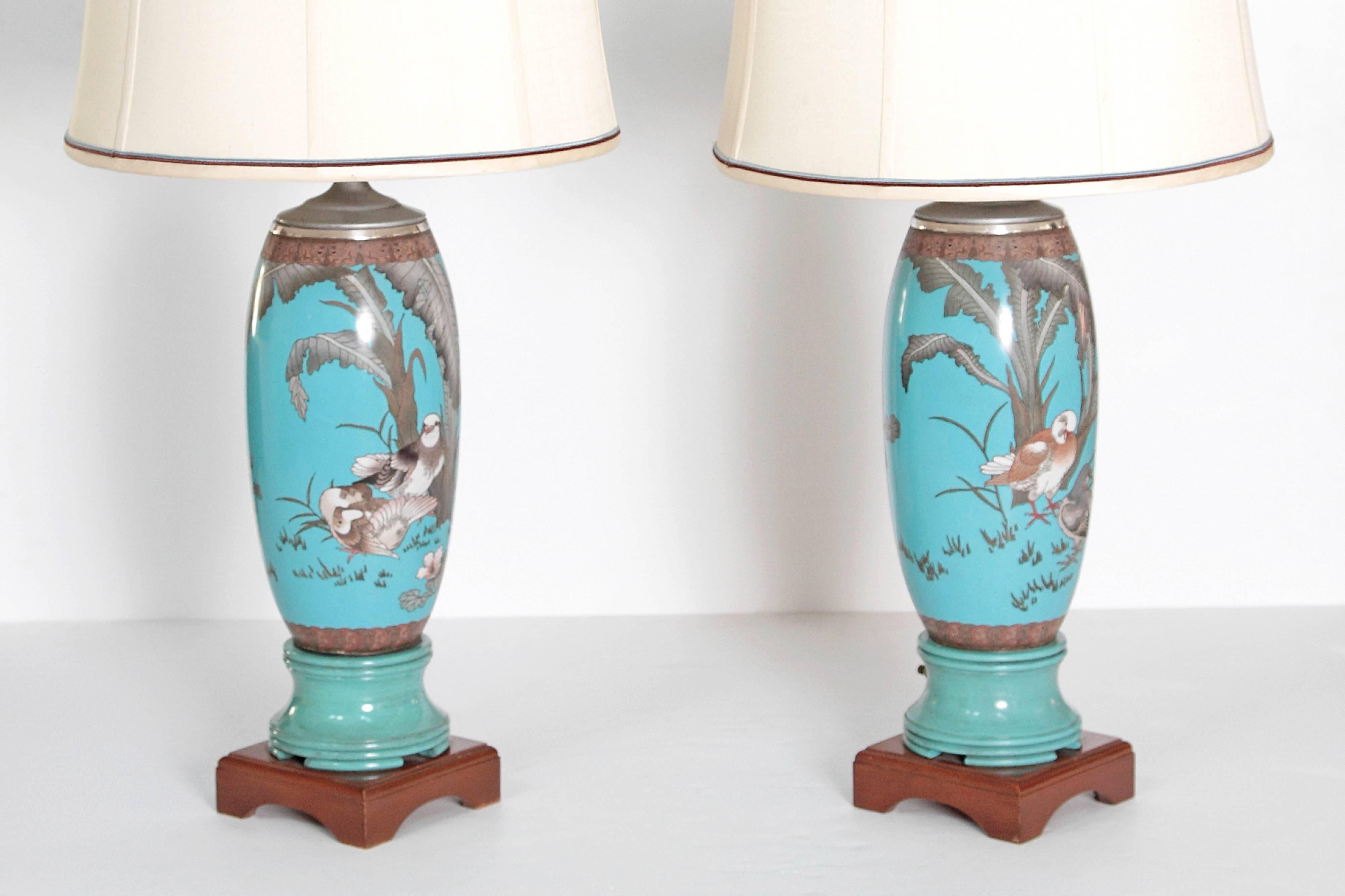 A pair of 19th century French cloisonne vases mounted as lamps. The body of the lamps are turquoise  with images of birds and foliage. Decorative 6 inch square bases.