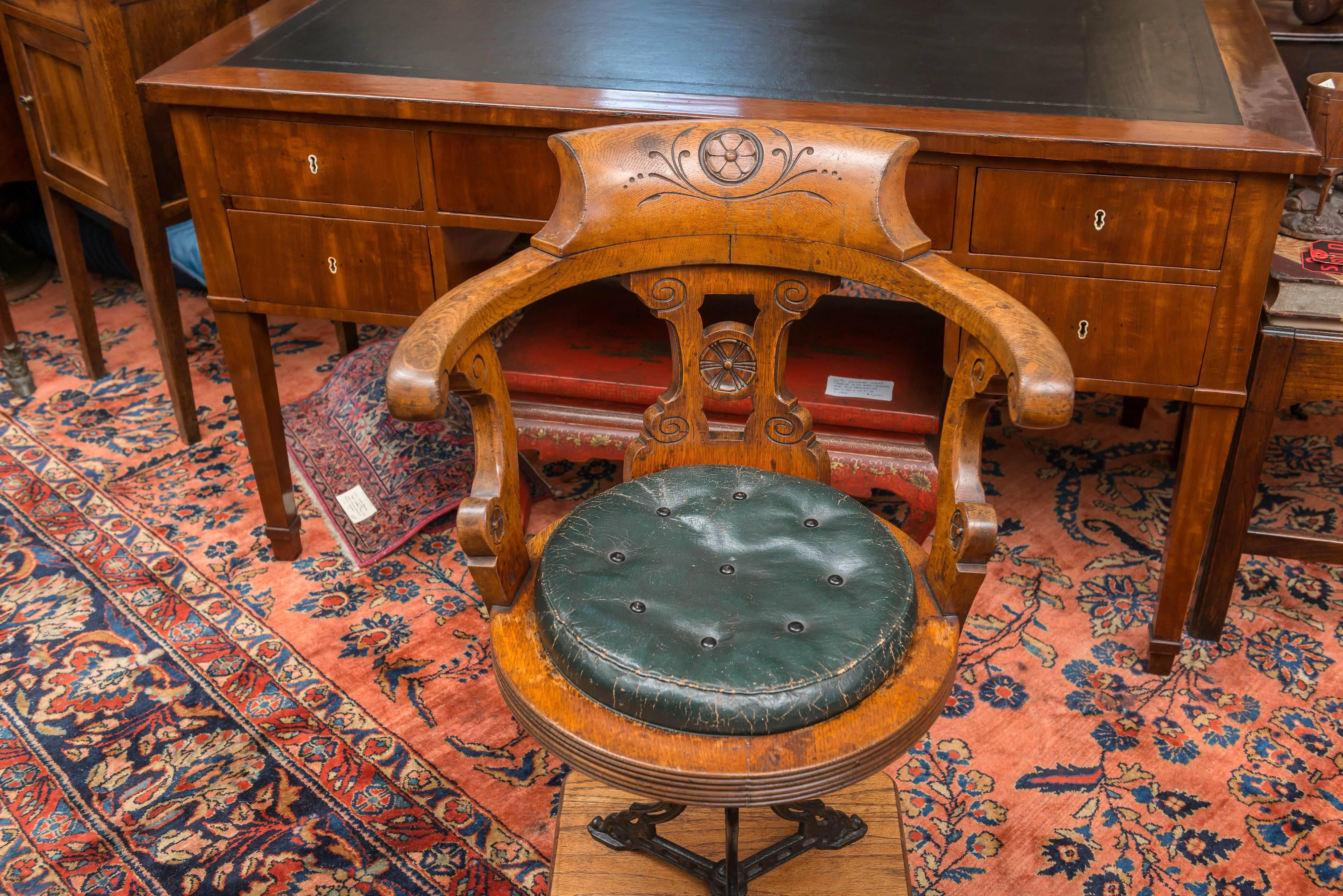 Late 19th century English ship's chair / stool. Authentic period nautical example.
Oak chair with a cast iron pivoting base and a leather button and tufted drop in cushion.
This chair rotates 180 degrees and stops. When rotating the chair pulls