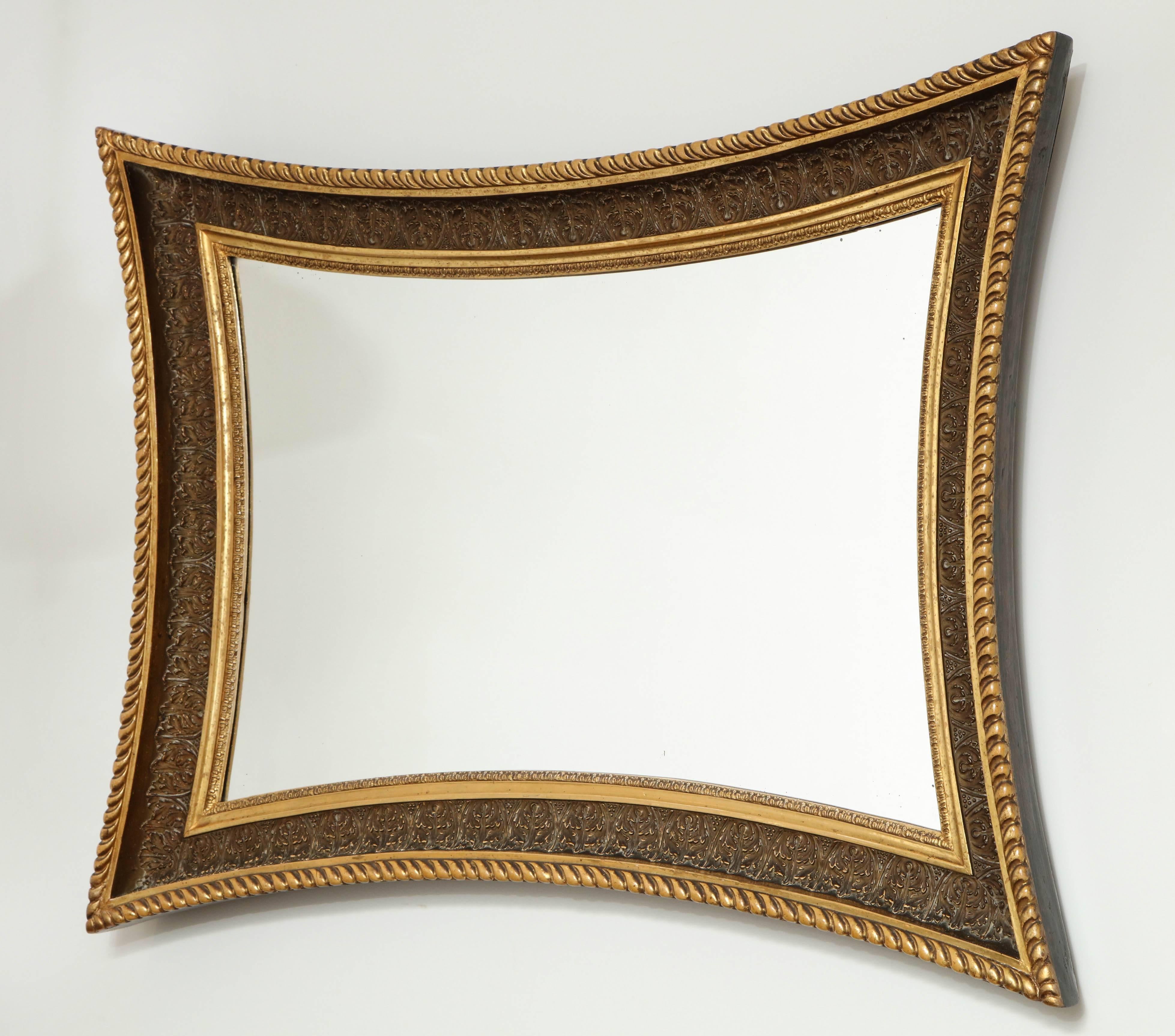 A Danish giltwood and painted mirror, circa 1860s, the concave frame with a gadrooned outer edge, painted leaf cast cove section and a foliate tip inner edge. Original surface with a lovely patina, old mirror glass.