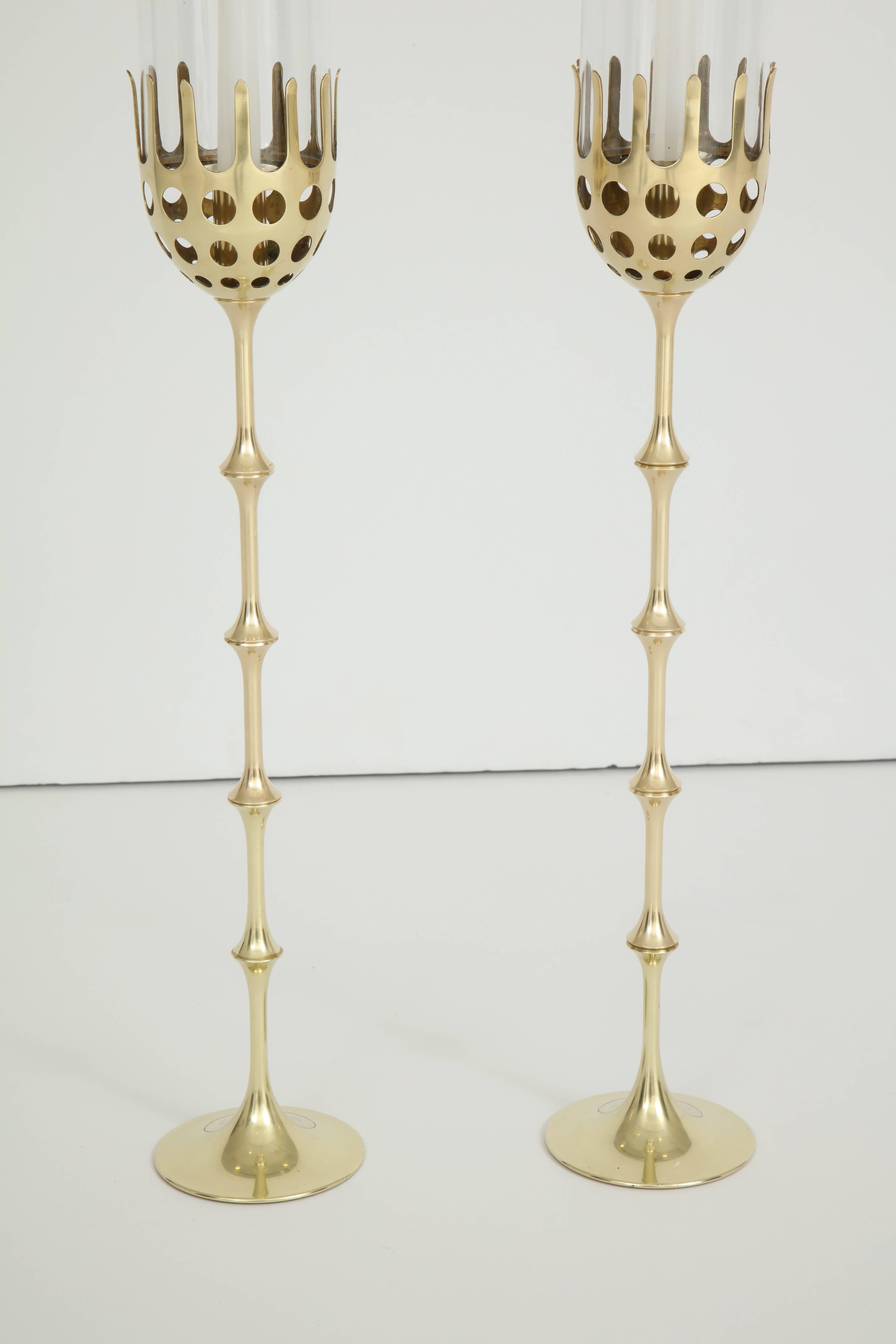 A pair of Bjorn Wiinblad polished brass and glass spool candlesticks with crown form candleholders, circa 1980s, Denmark. The spools are adjustable to create different heights.