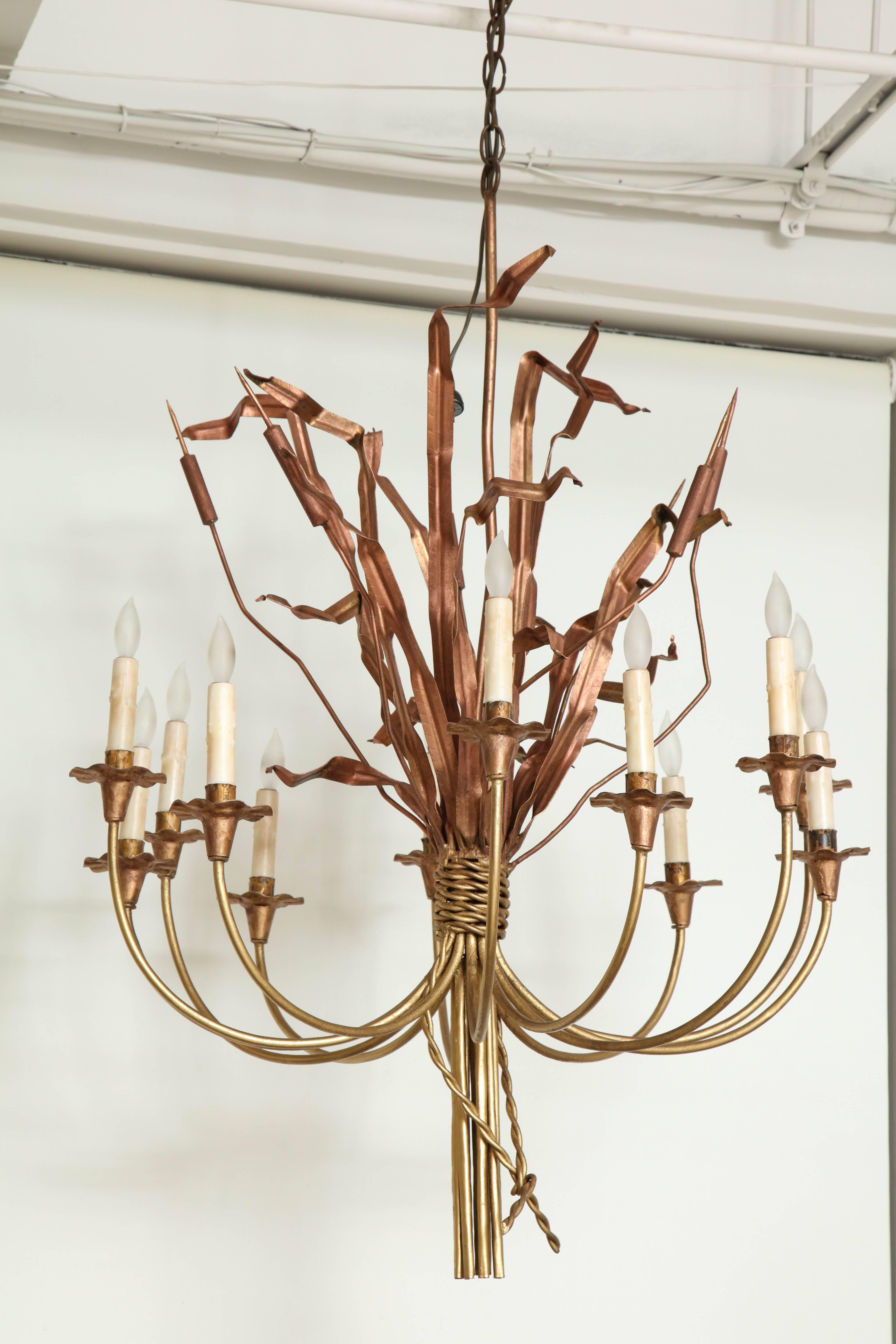 12 lights surround a bundle of cattails on this unique gilded chandelier