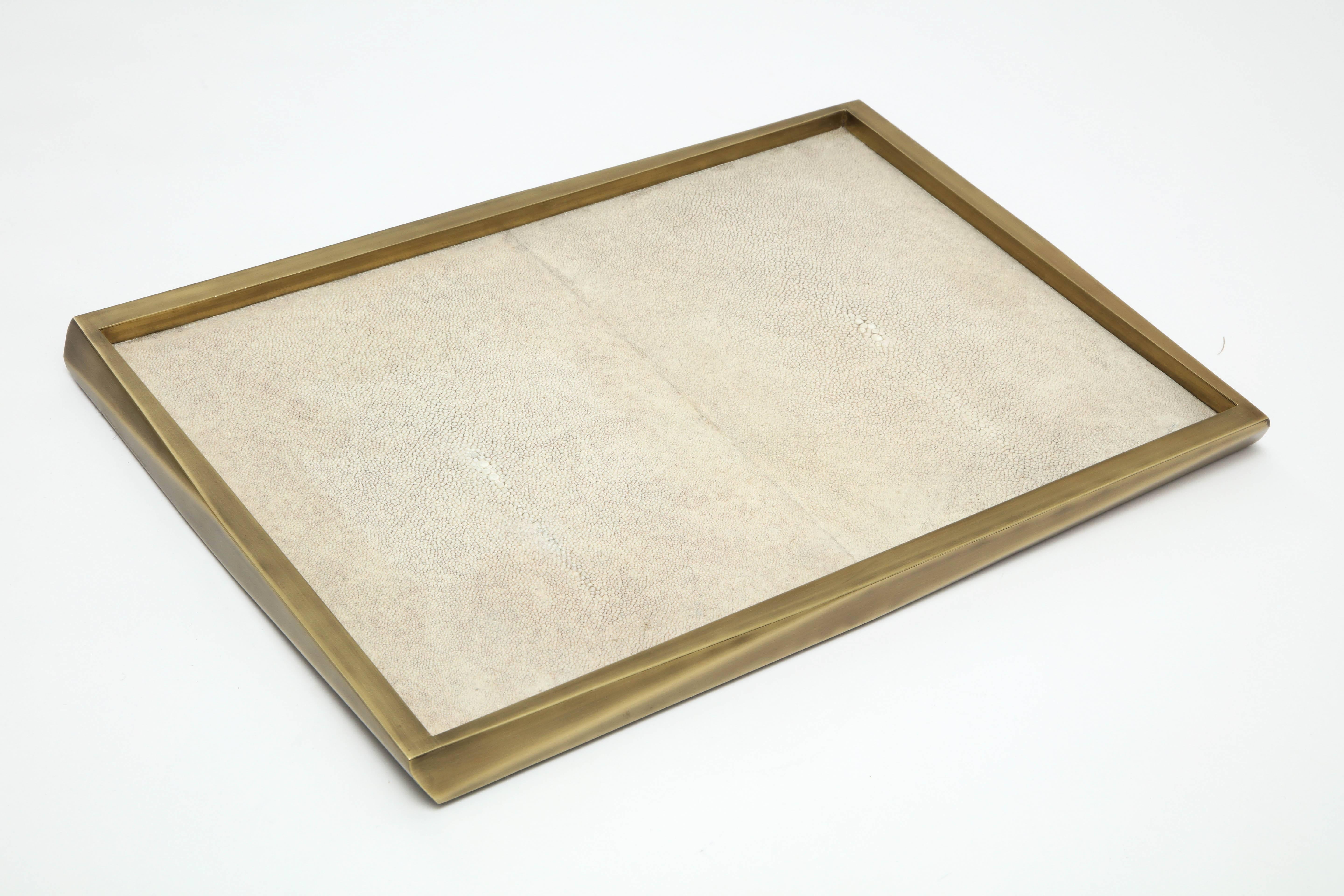Cream colored shagreen tray with bronze border.