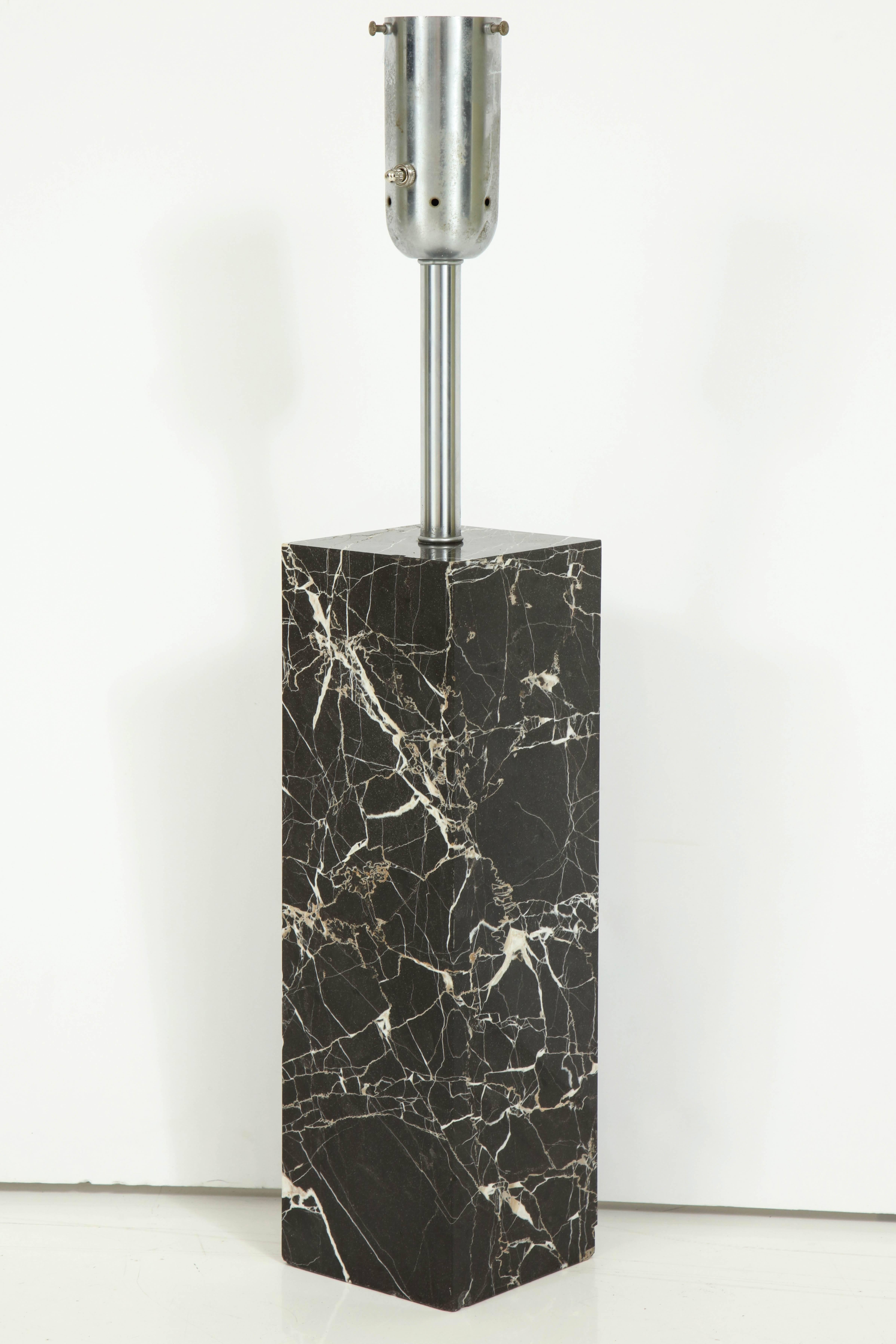 A large veined black Carrara marble table lamp. A diffuser and shade will be added.