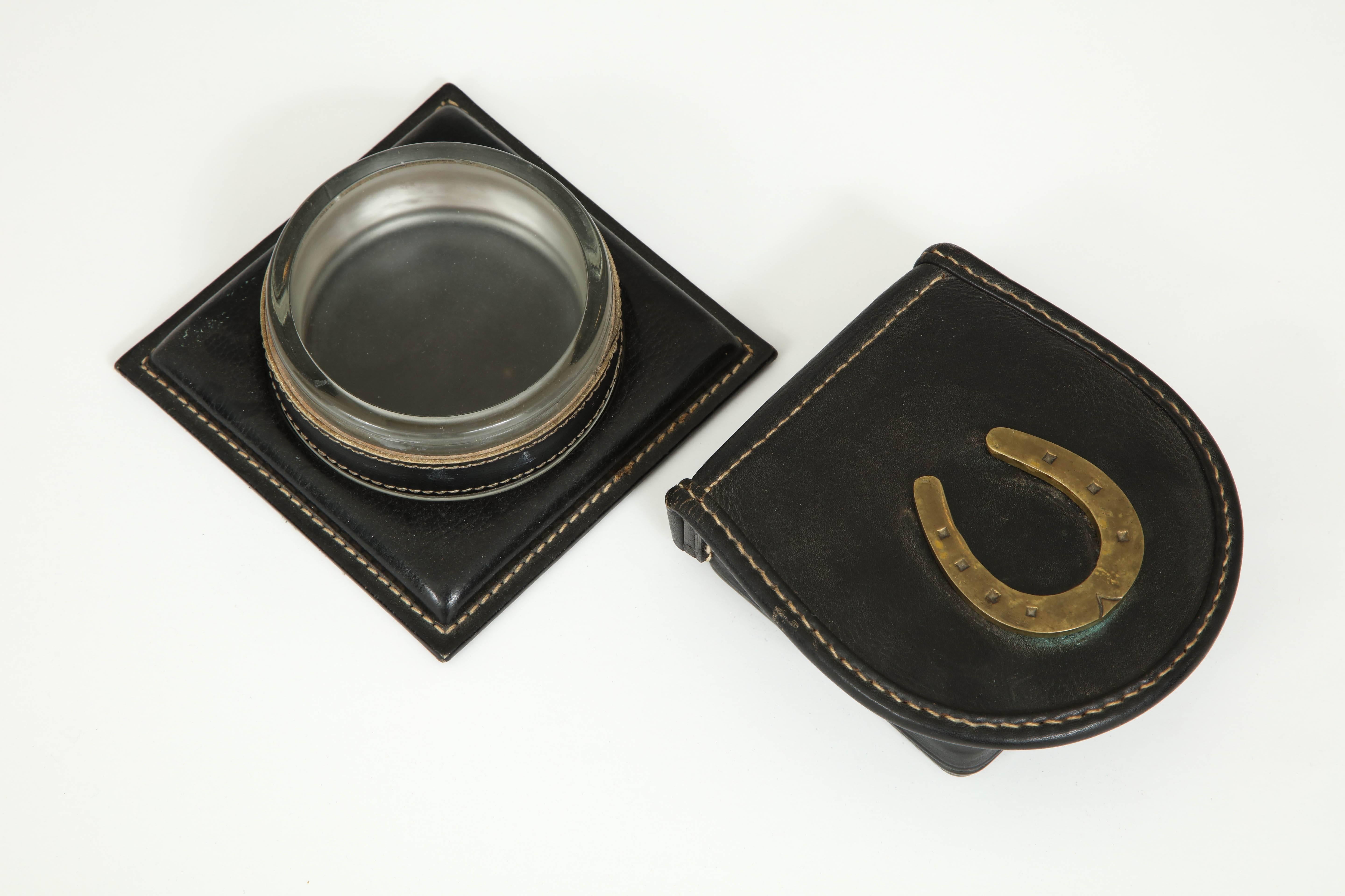 A catchall and a lidded box by Jacques Adnet, glass, brass and stitched leather.
Sold as a set or separately (divide price by two).