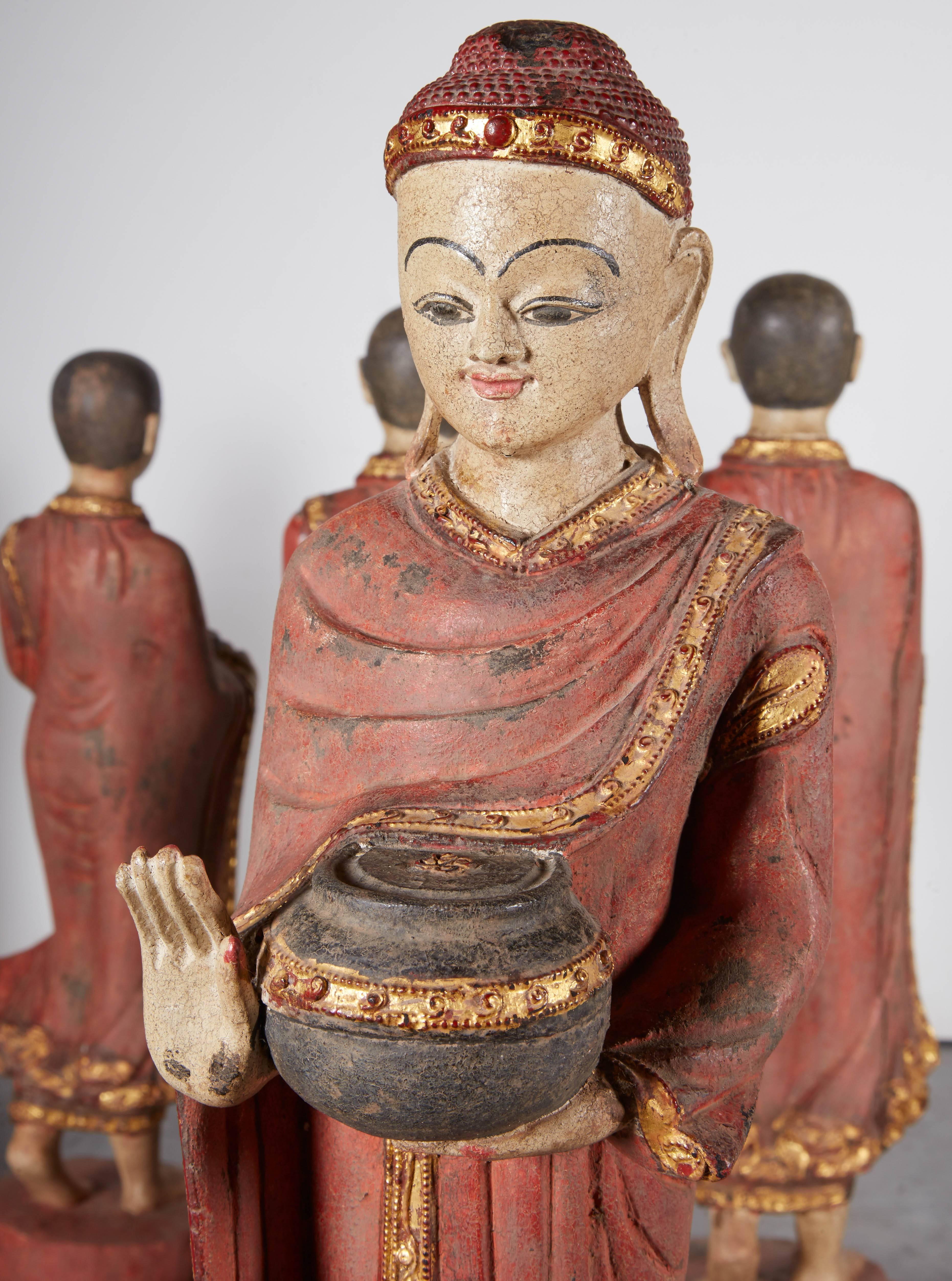 A complete set of five intricately carved vintage Burmese monks and Buddha in flowing robes on lotus leaf and carrying alms bowls. Spiritual and beautiful, these pieces are extraordinarily detailed (see additional photos). 
Dimensions: 
largest