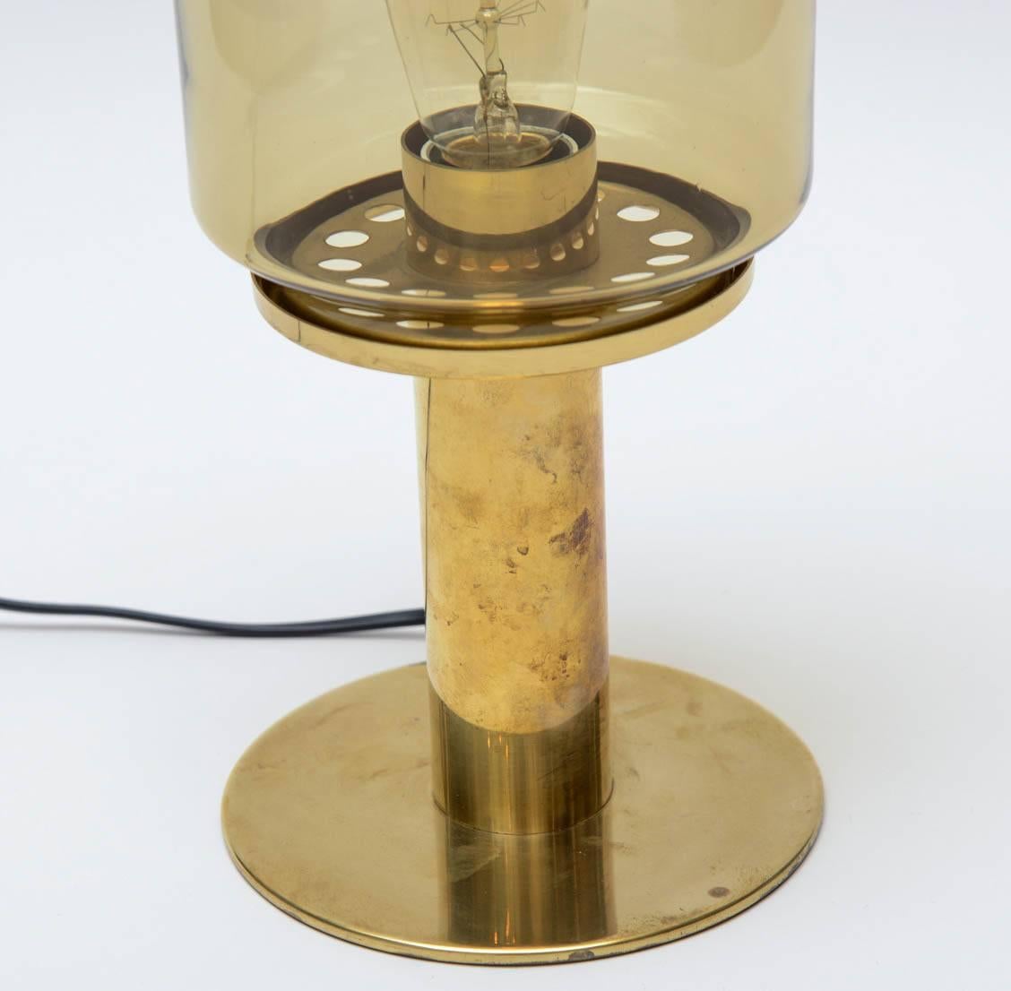 Pair of brass lamps with handblown smoked color glass shade designed by Hans-Agne Jakobsson and produced by his own company in Markaryd, Sweden. Model B102, original stickers at the bottom, new wiring.
