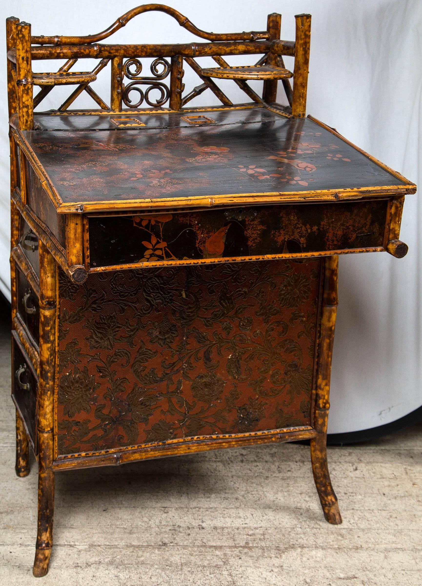 hand painted with flowers, birds and  vines.  the top lifts  up. there are   3  shelves on the left side, and  3  drawers  on the right.
pressed material on the front panel and inside

damage to  front  corner has  been repaired
