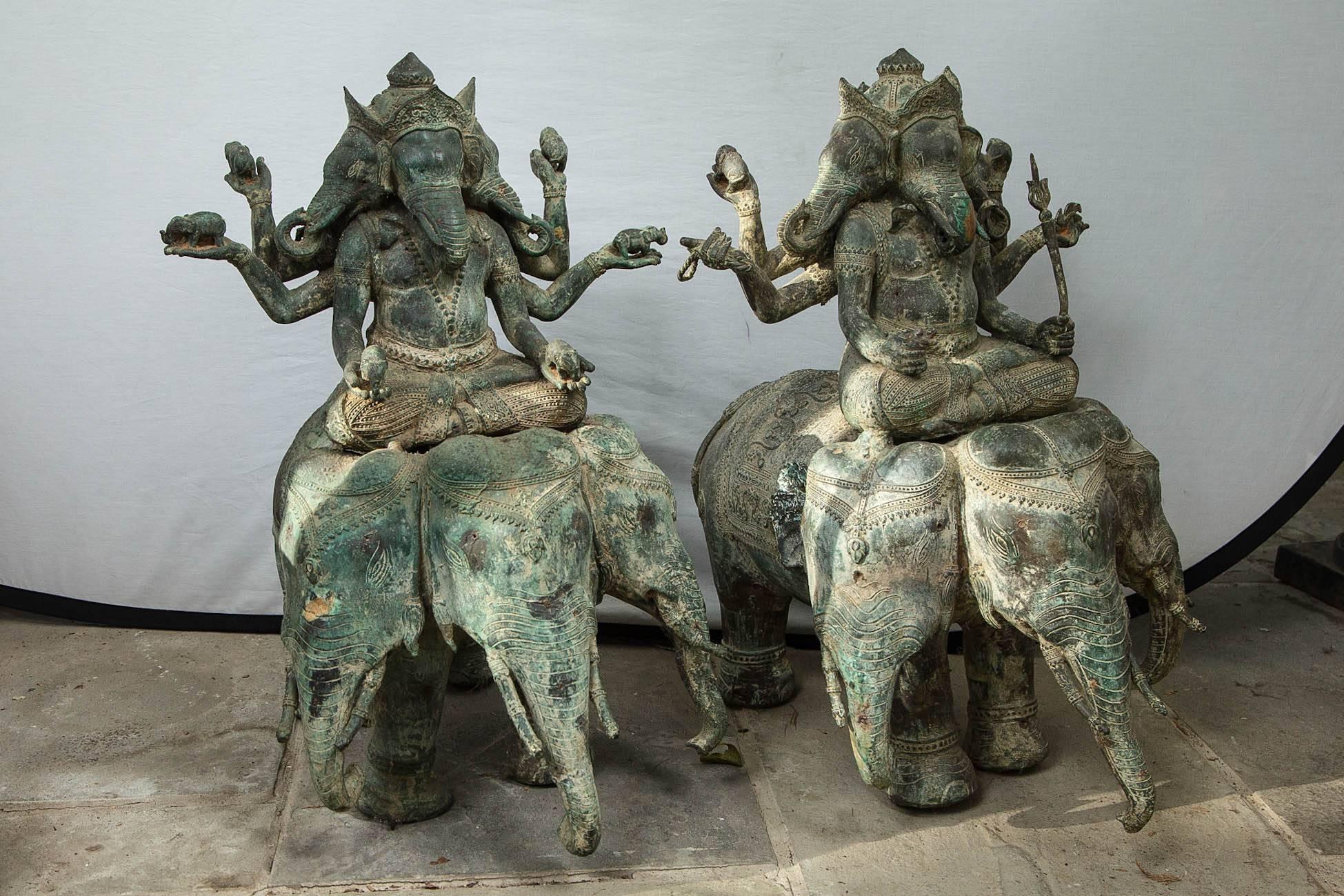 Three elephant heads on the body of each and being ridden by gods each with three elephant heads. Human arms holding symbols of his powers.

 