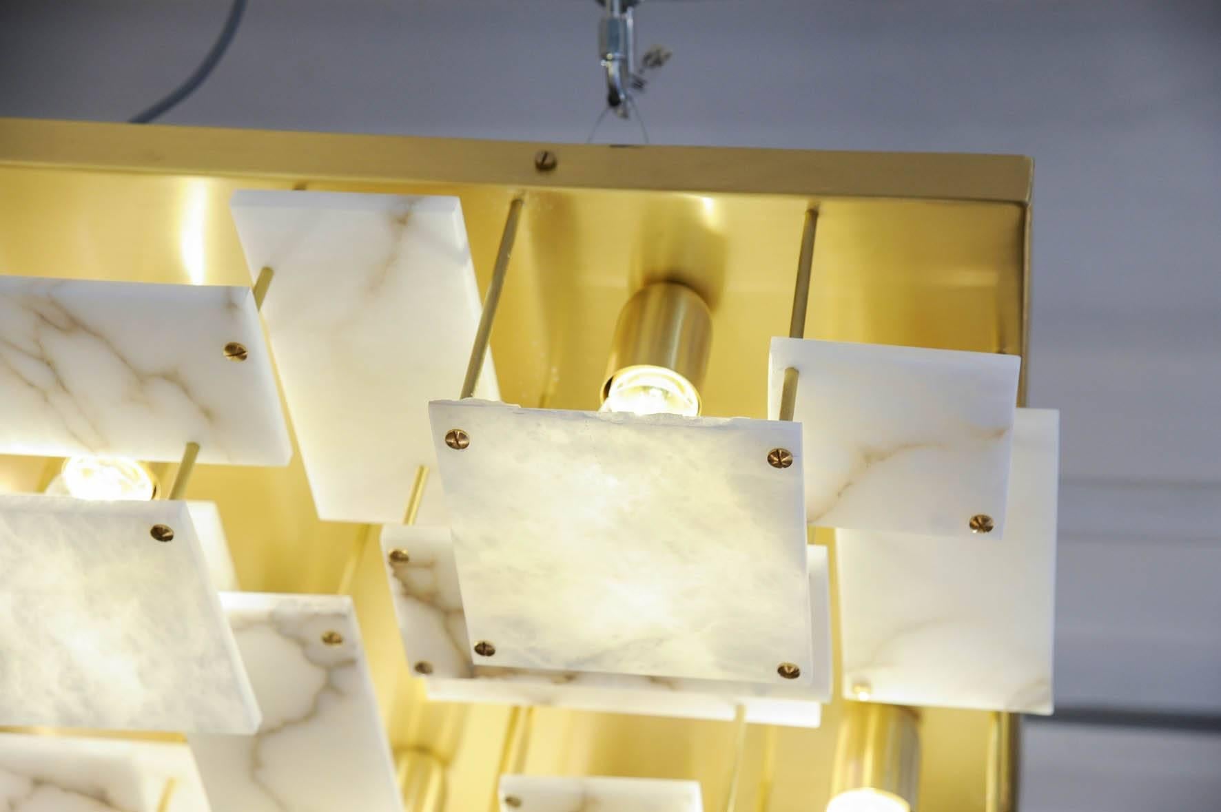 New design by Glustin Luminaires, ceiling lamp made of an aluminium structure, covered with a brass plate on which are disposed in superposition alabaster tiles.

Can also be placed on the wall for a great wall sconces.