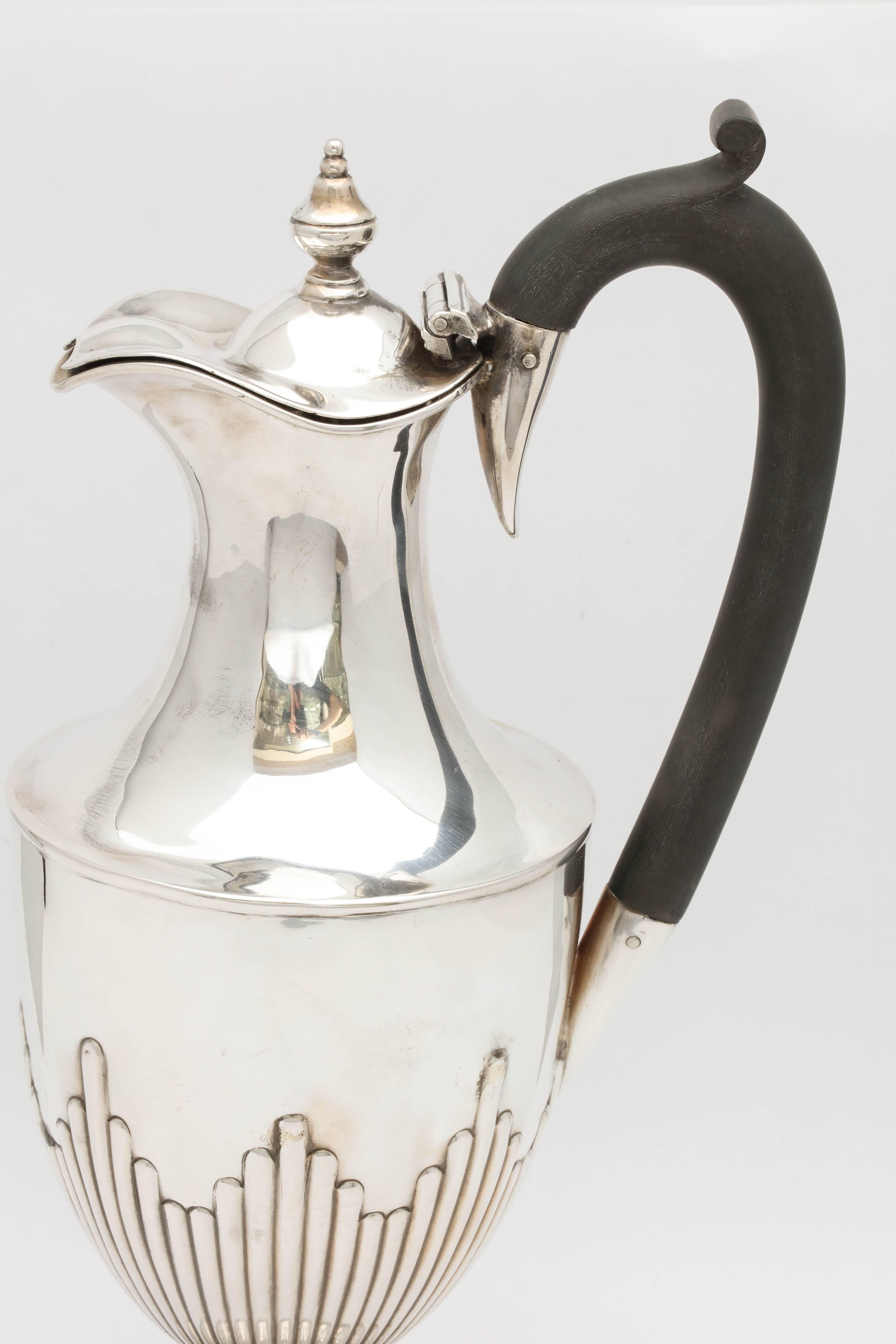 Graceful, Victorian, sterling silver ewer on pedestal base and having a hinged lid and a wooden handle, London, 1890, John A. Lowinkle and Thomas Slater, makers. Lovely, fluted design. Measures: 10 inches high (at highest point) x 4 inches diameter