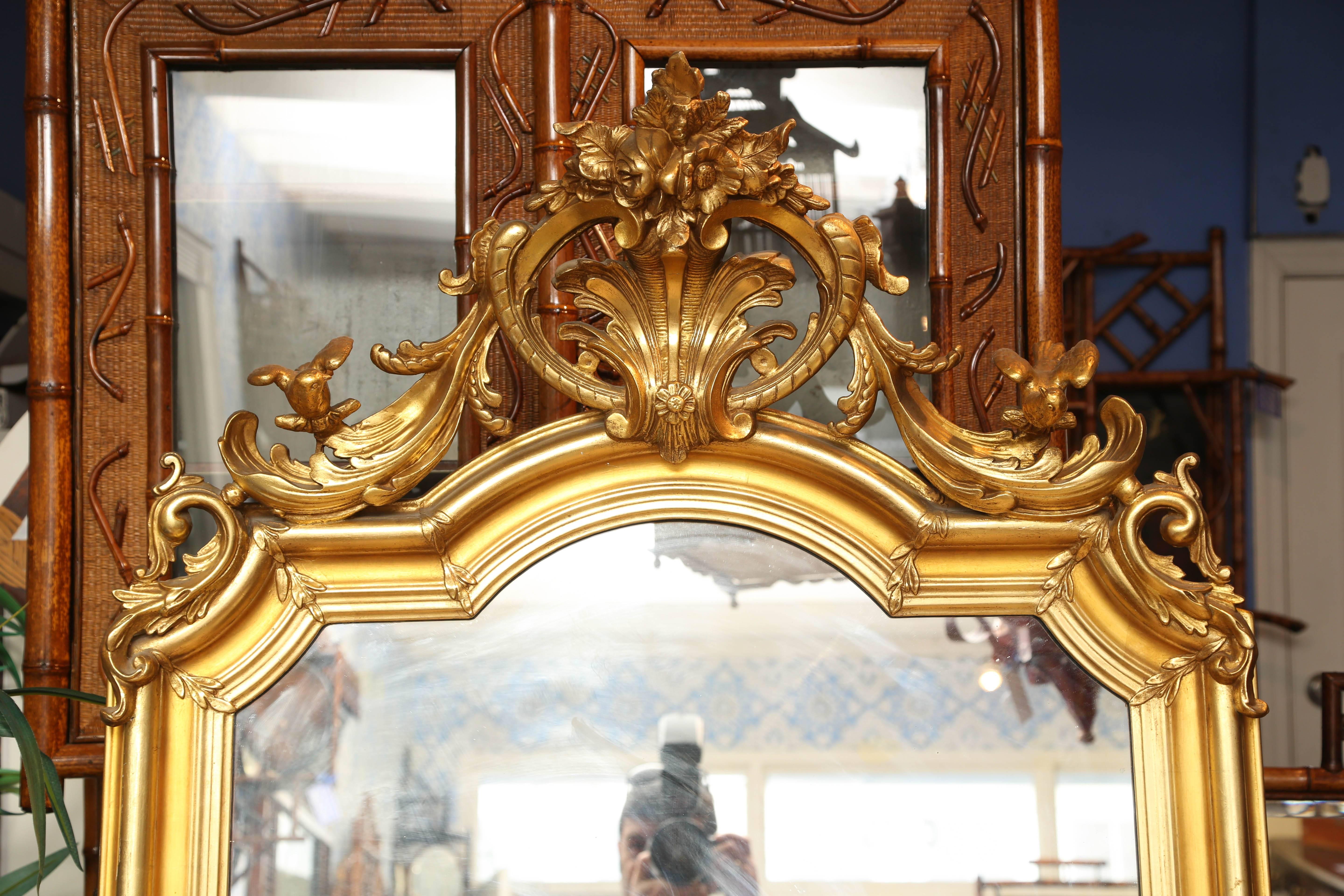 This is a superb quality gilt French antique freestanding or wall mirror.
The gilt work is all original and in excellent condition.
There are carved birds to either side at the top.
With Rocco style carving to the center.
Measurements are 78