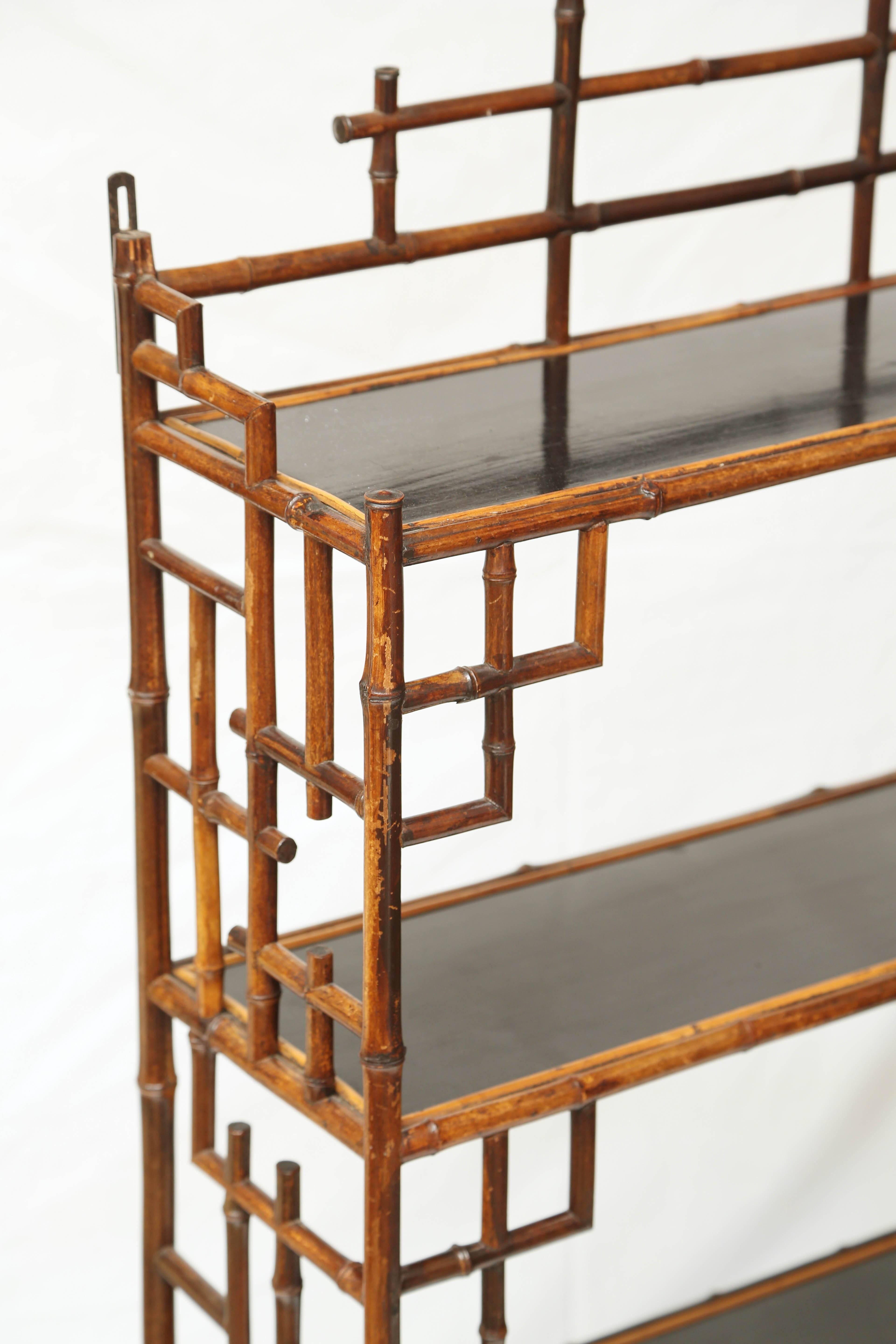 Beautiful hanging 19th century bamboo étagère with two drawers.
Measures 44/24.5/8 inches. Original purchase price of approximately $3,000. From a Greenwich, Connecticut estate decorated by Nina Campbell.


   