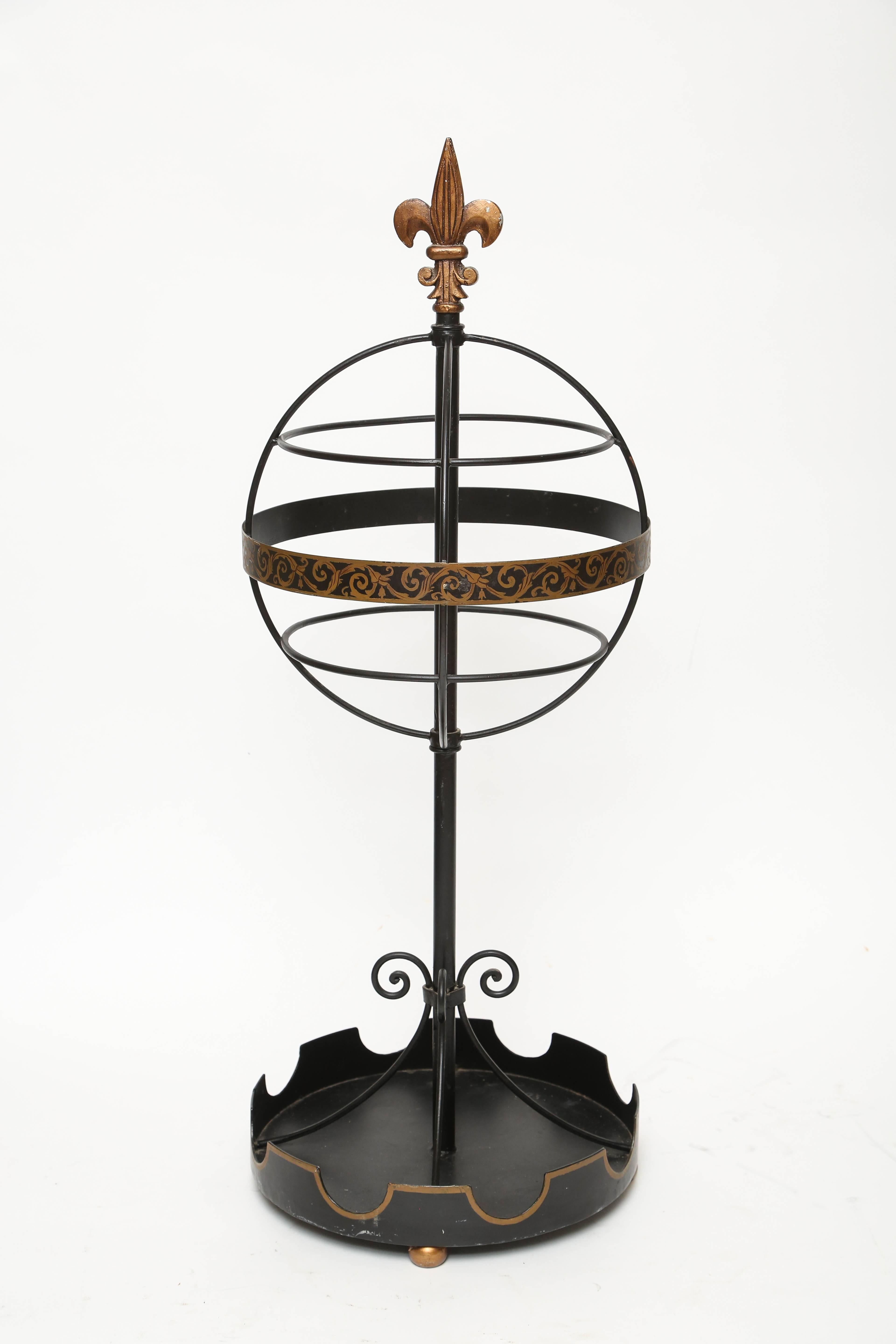 Charming French tole umbrella stand with sphere topped by a fleur de lys.