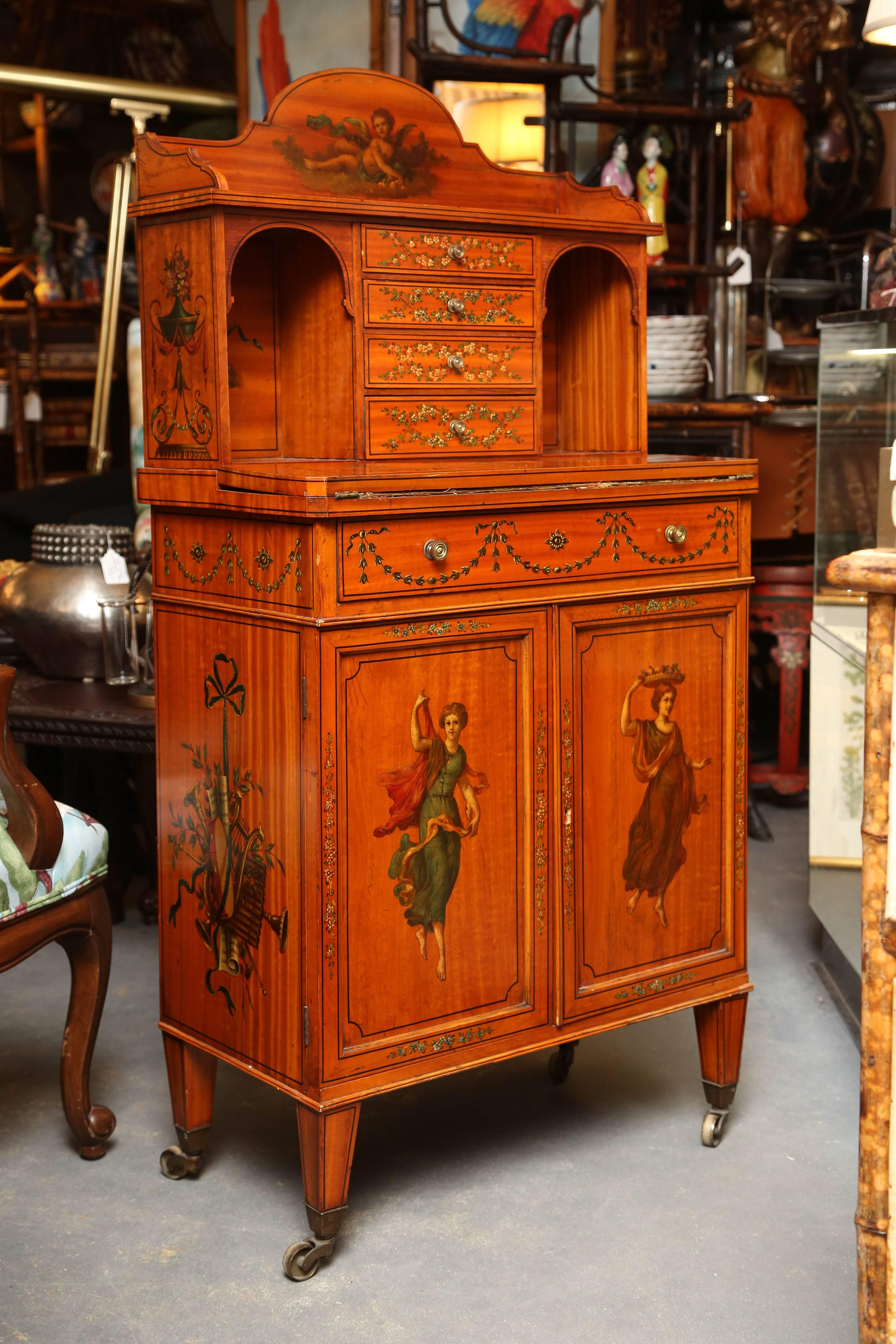 Exquisite detail and exceptionally fine hand paintings adorn this sweet and compact desk.
Fine quality satinwood. A rare example.