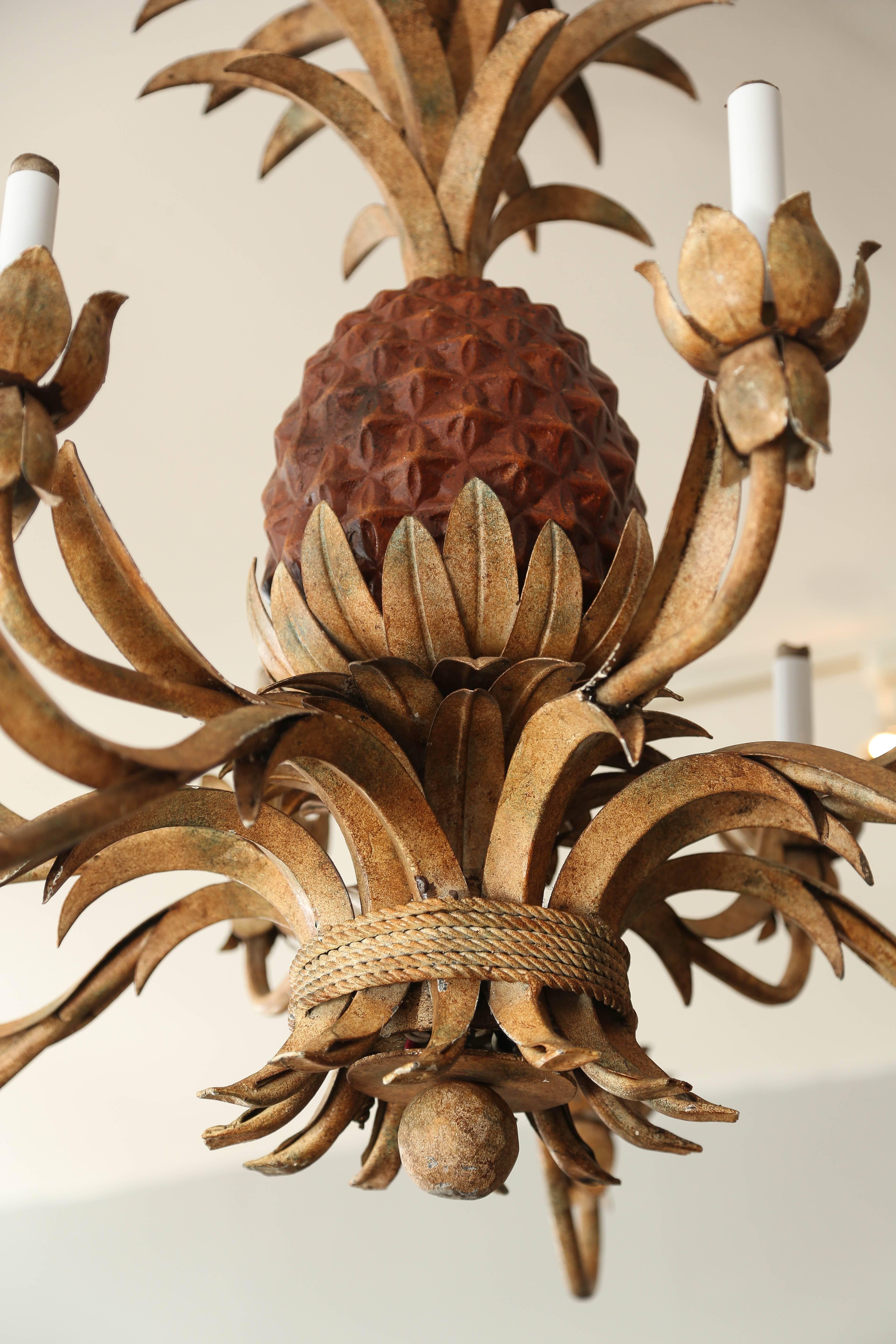 Magnificent twelve-light chandelier of generous proportions original paint.
The central pineapple is larger than lifesize and finely fashioned.