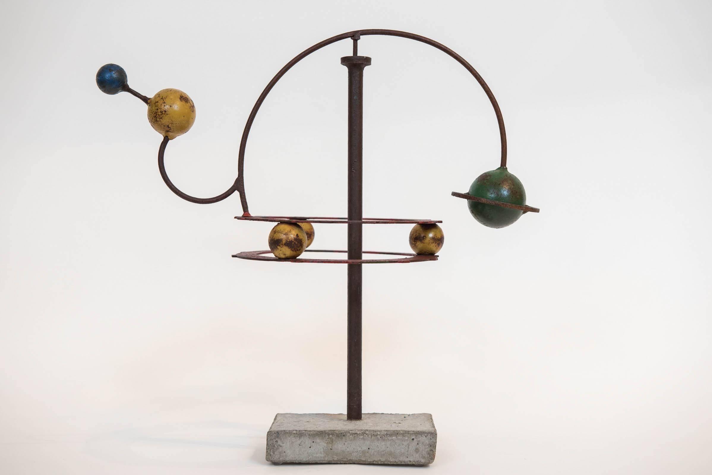 This fun and funky orrery made in iron with a concrete base rests atop a single post structure that allows it to balance and rotate like a mobile.
