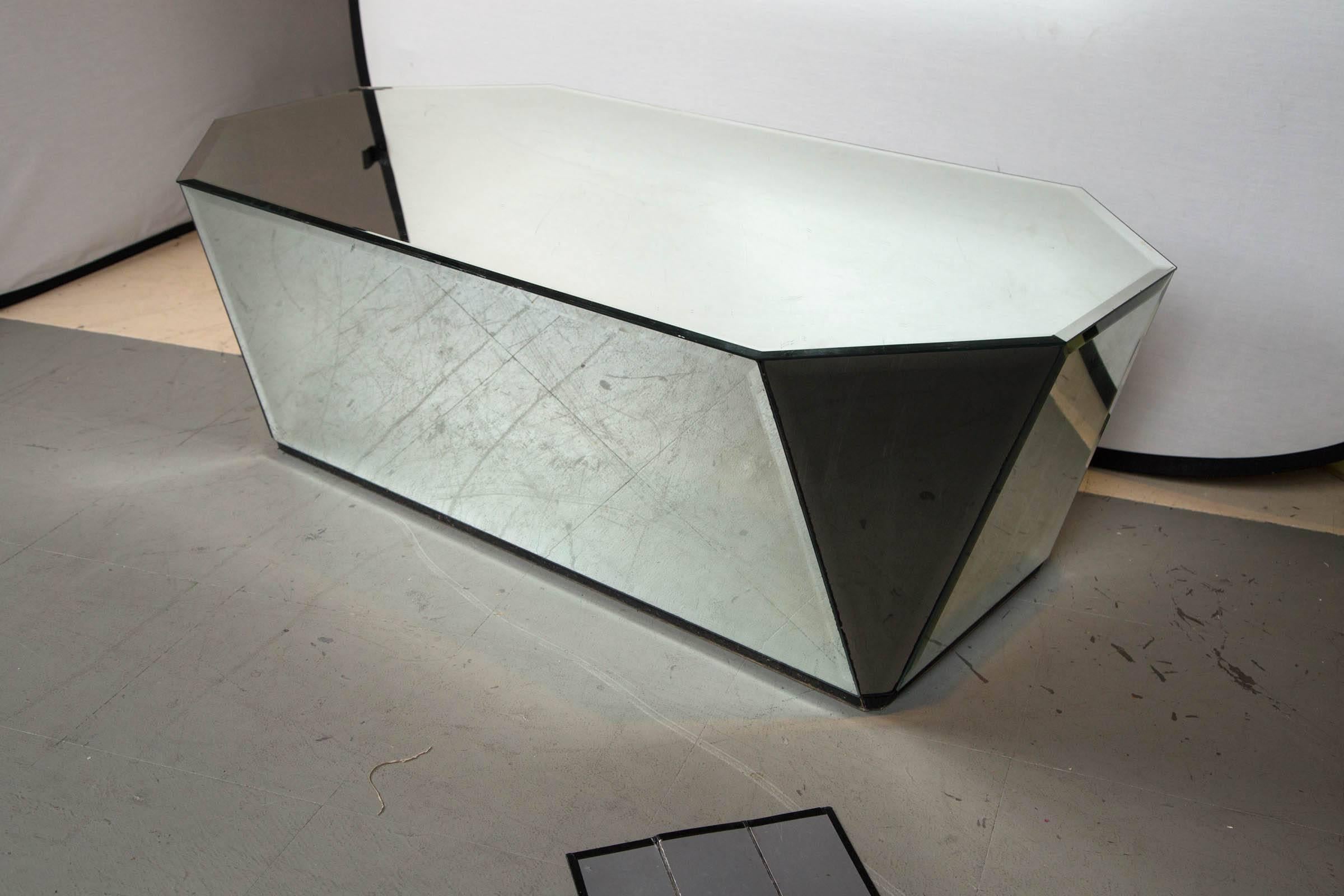 A art form mirrored coffee or cocktail table, circa 1970s. Having geometric angular mirrored panels in an artistic sculptural modernist style great as an show piece or for everyday use. Some minor surface scratches consistent with age no breaks or