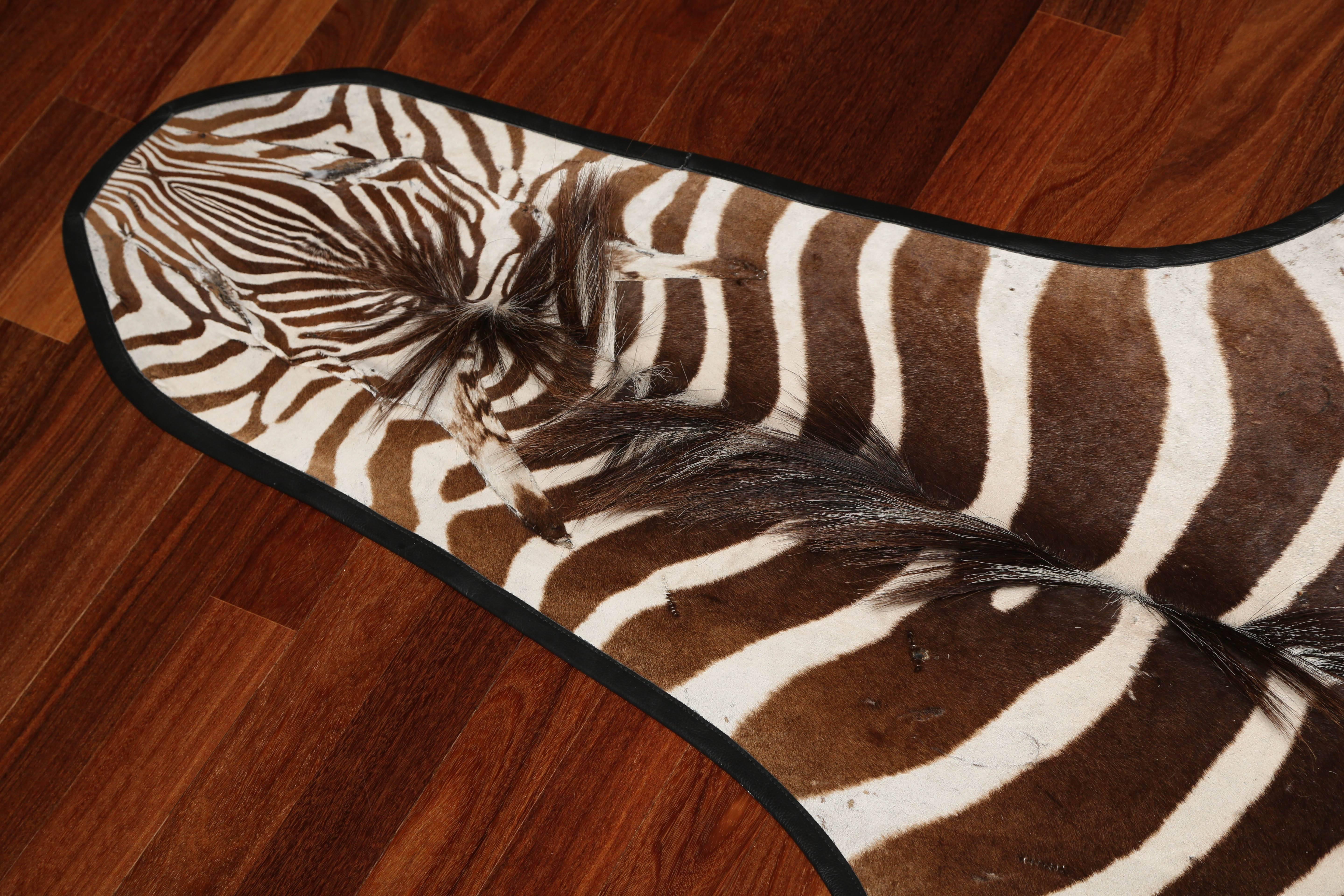 Zebra hide trimmed in leather. There are two available.