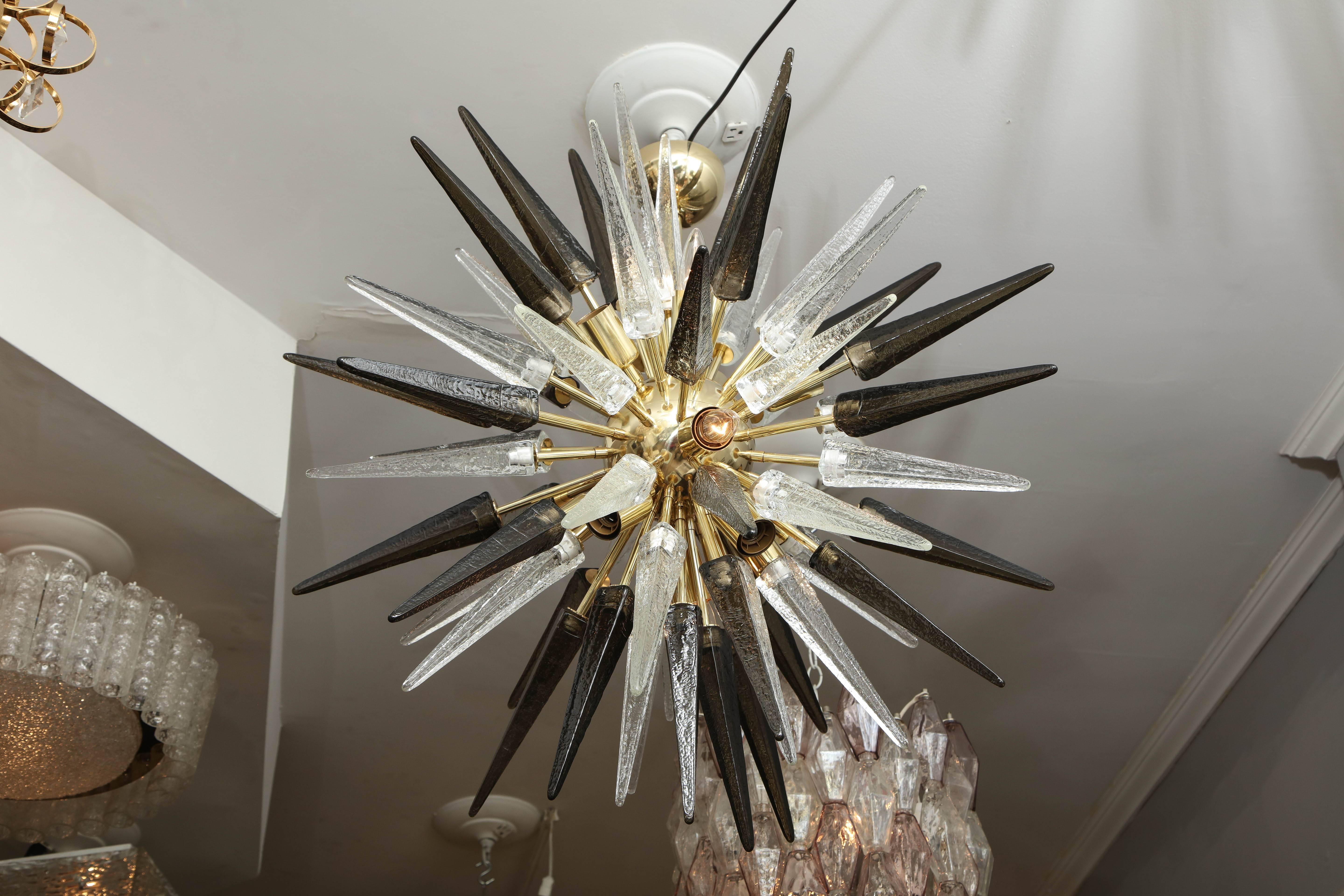 Smoke and clear Murano glass spike Sputnik chandelier with polished brass finish frame. Customization is available in different sizes, finishes and glass colors.